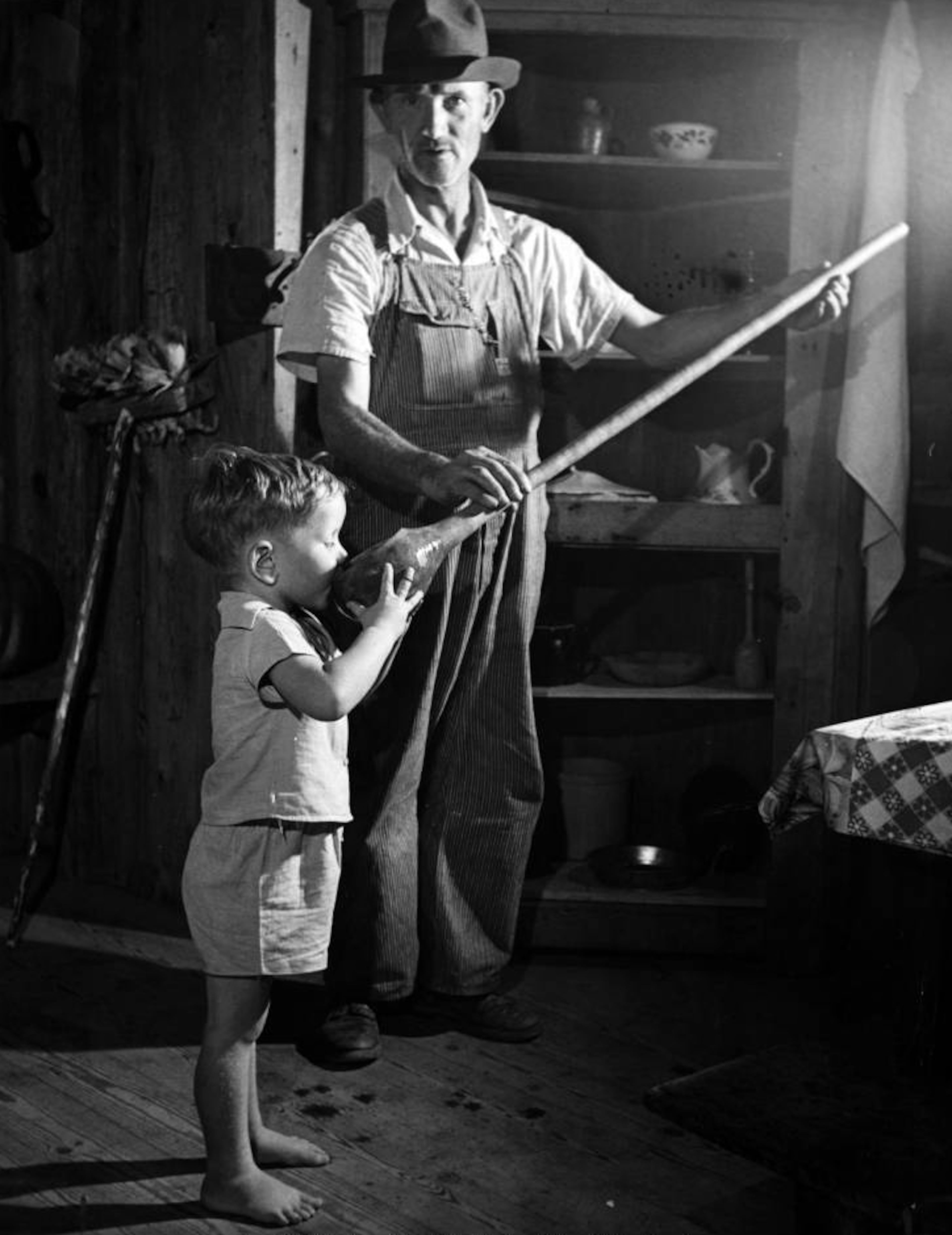 Lant J. Ellers, Ed Watkins' grandson, drinks from a long-handled gourd, Mountain City, Georgia, ca. 1930s; 1940s.
