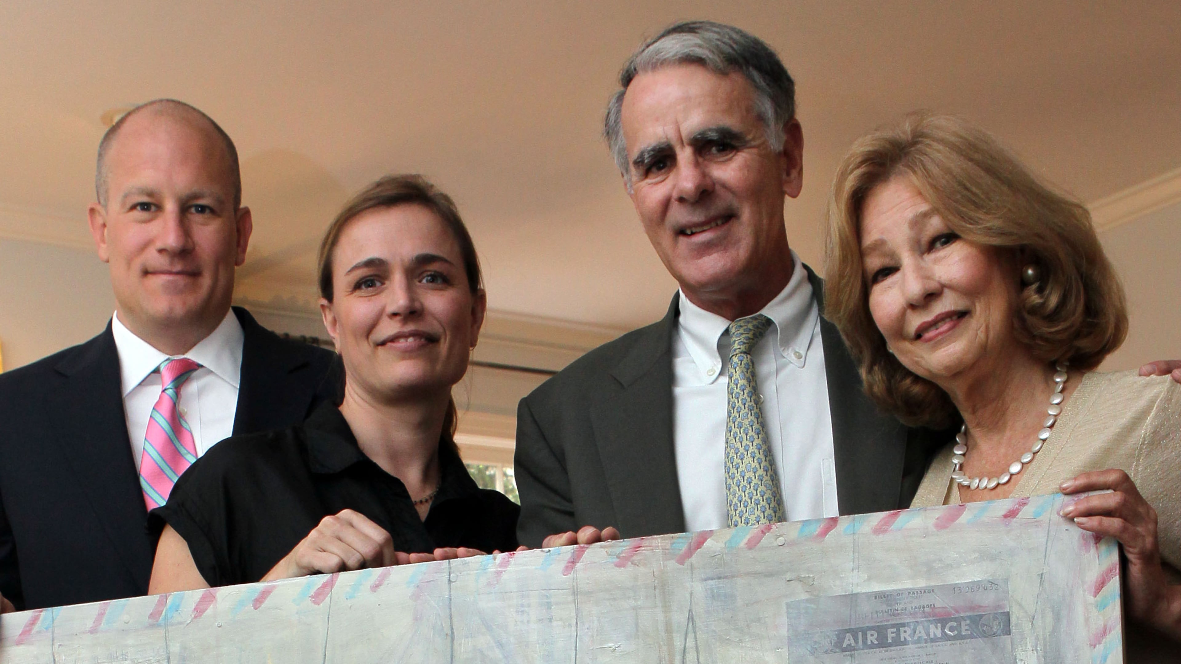 Wright Mitchell (left to right), Katherine McClure, Frank Virgin and Penny Hart hold a painting by McClure.