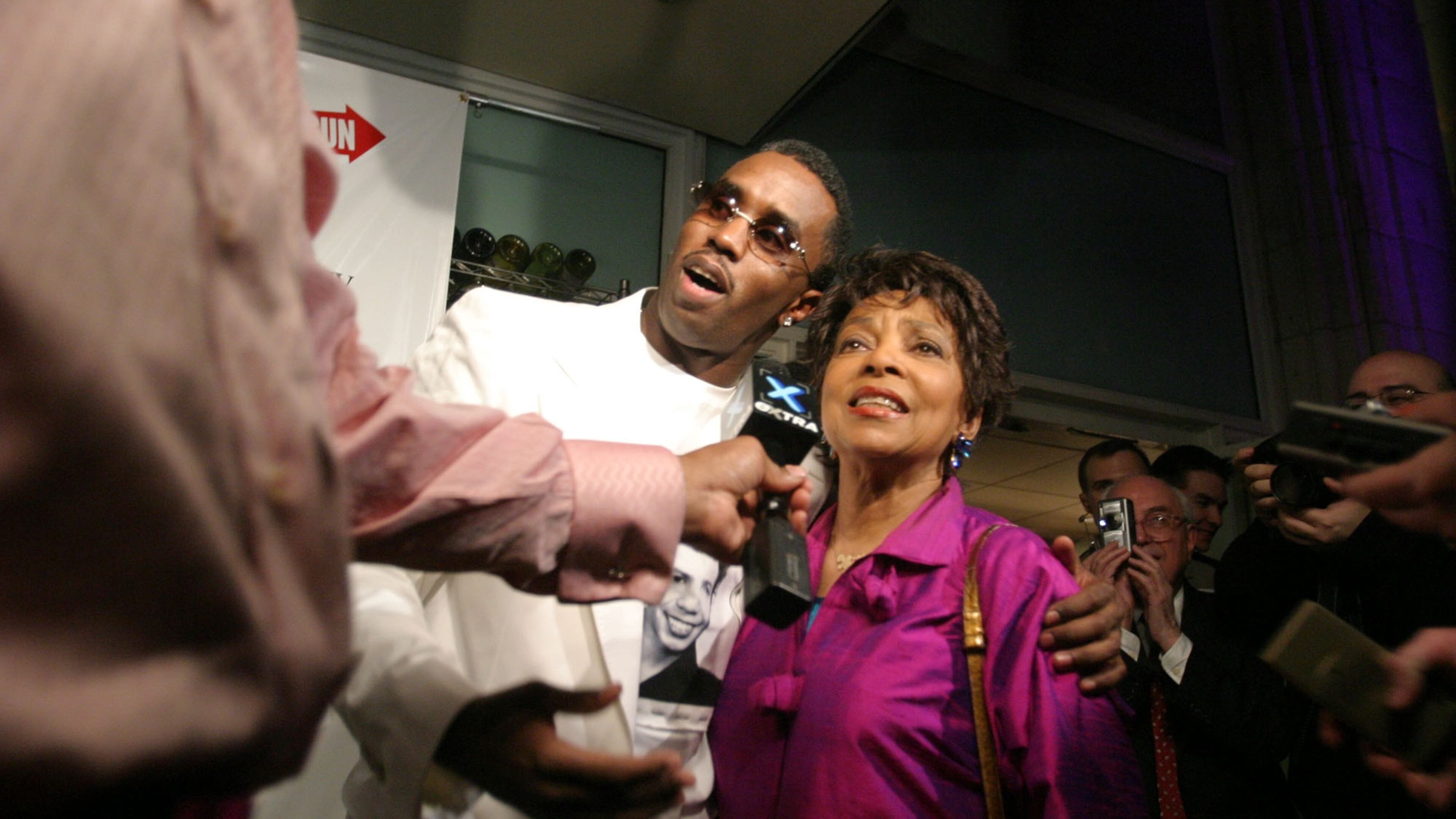 SPECIAL TO THE ATLANTA JOURNAL CONSTITUTION - Sean Combs, left, hugs Ruby Dee, right, as they are interviewed by the media at the after party in New York celebrating the opening night of Lorraine Hansberry's 'A Raisin in the Sun' on Broadway Monday April 26, 2004. Combs stars in the play directed by Kenny Leon. (AP Photo/Tina Fineberg)