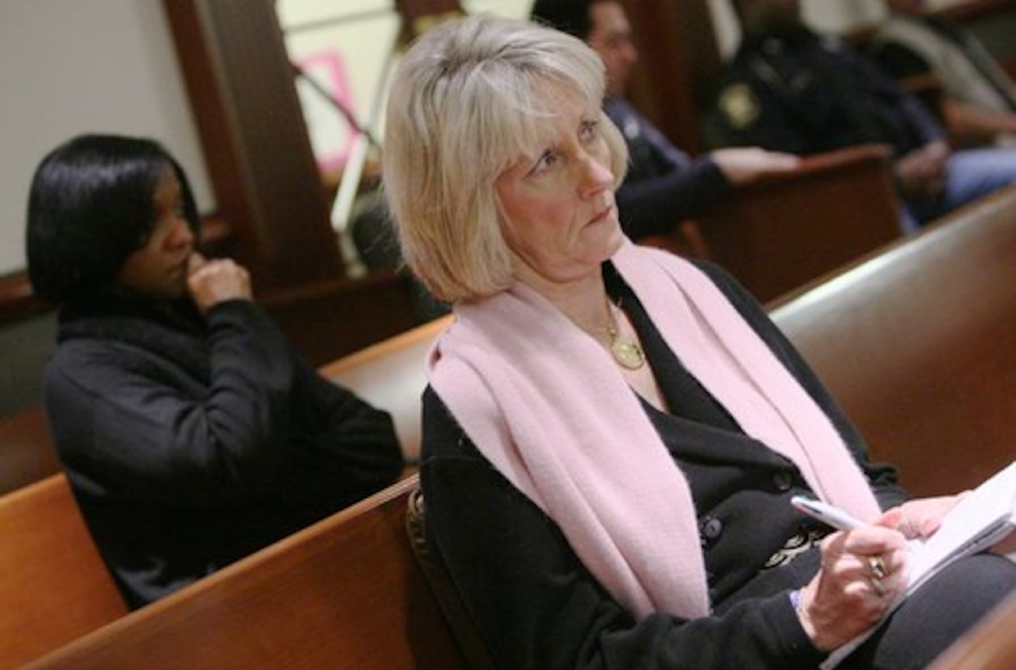 Debra Teasley (left) and Claudia Barnes (right) listen to Amanda Grihm's testimony.