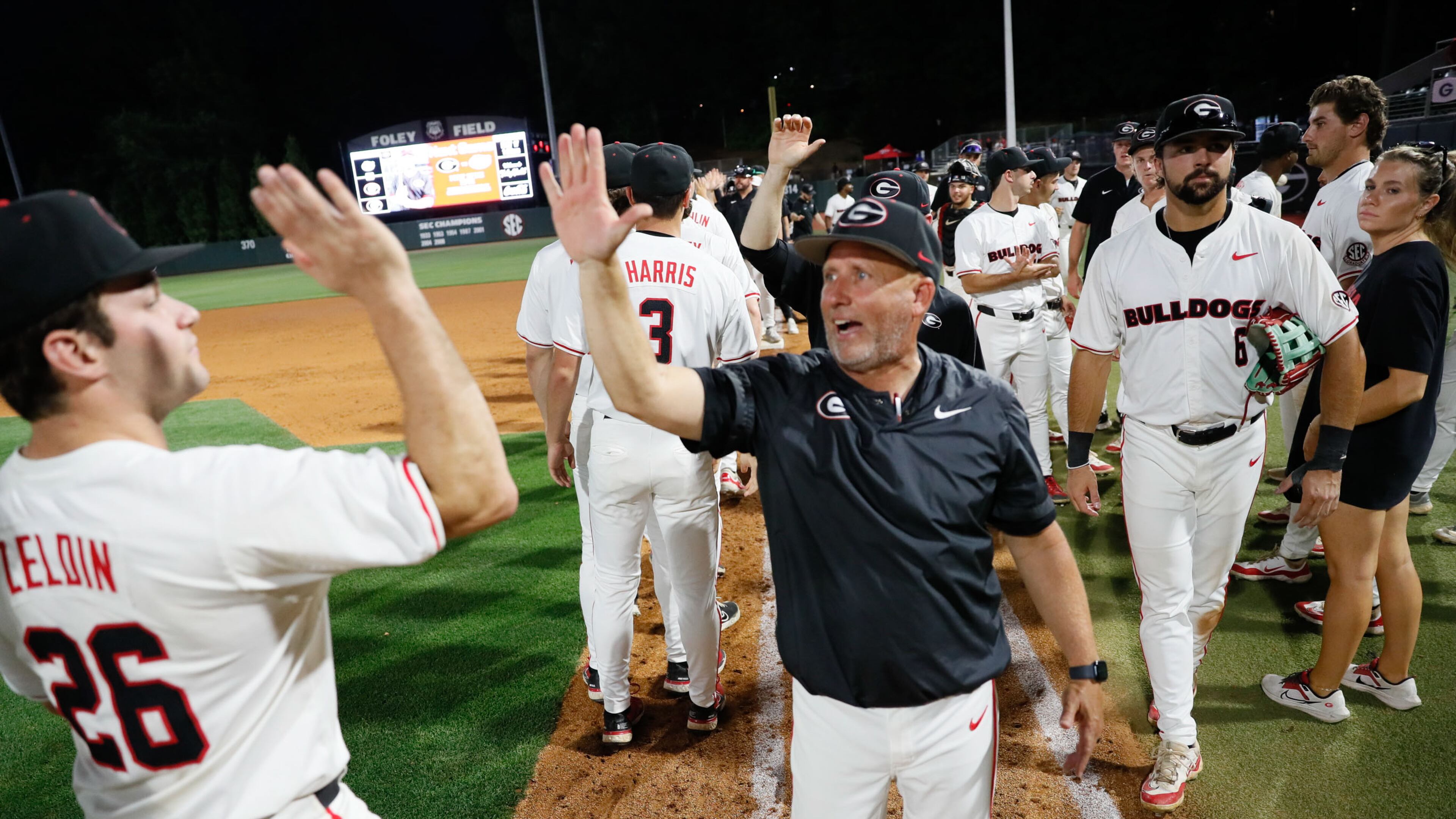 Georgia head coach Wes Johnson high-fives his players after a win last season.
(Miguel Martinez / AJC)