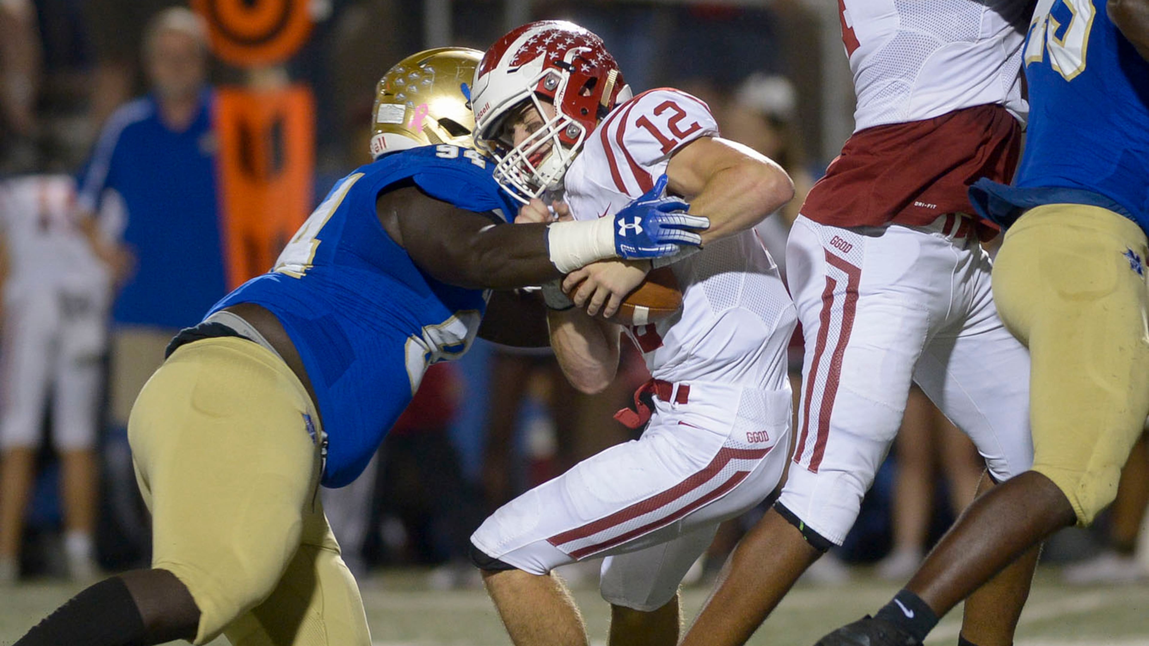 Cobb County rivals square off: McEachern defensive linebacker Anthony Harris (94) sacks Hillgrove quarterback Matthew McCravy (12) in the first half of Friday's game at McEachern. (Daniel Varnado/Special)