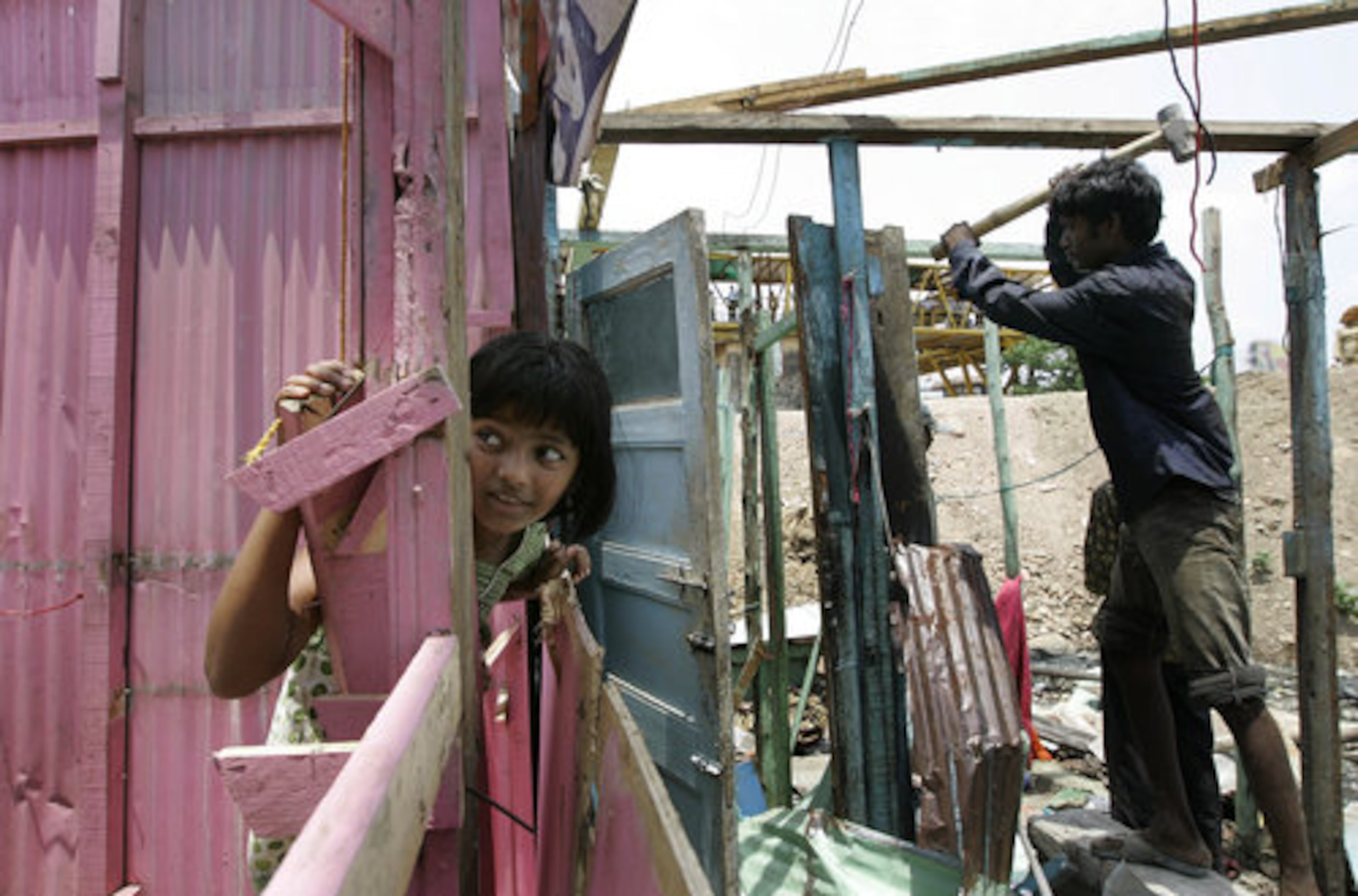 Rubina Ali watches as her house is demolished by local authorities. Dozens of police armed with bamboo batons supervised demolition crews of young men wielding sledgehammers and metal rods who tore down the shanty homes. The home of Ayush Manesh Khedekarl was also destroyed.