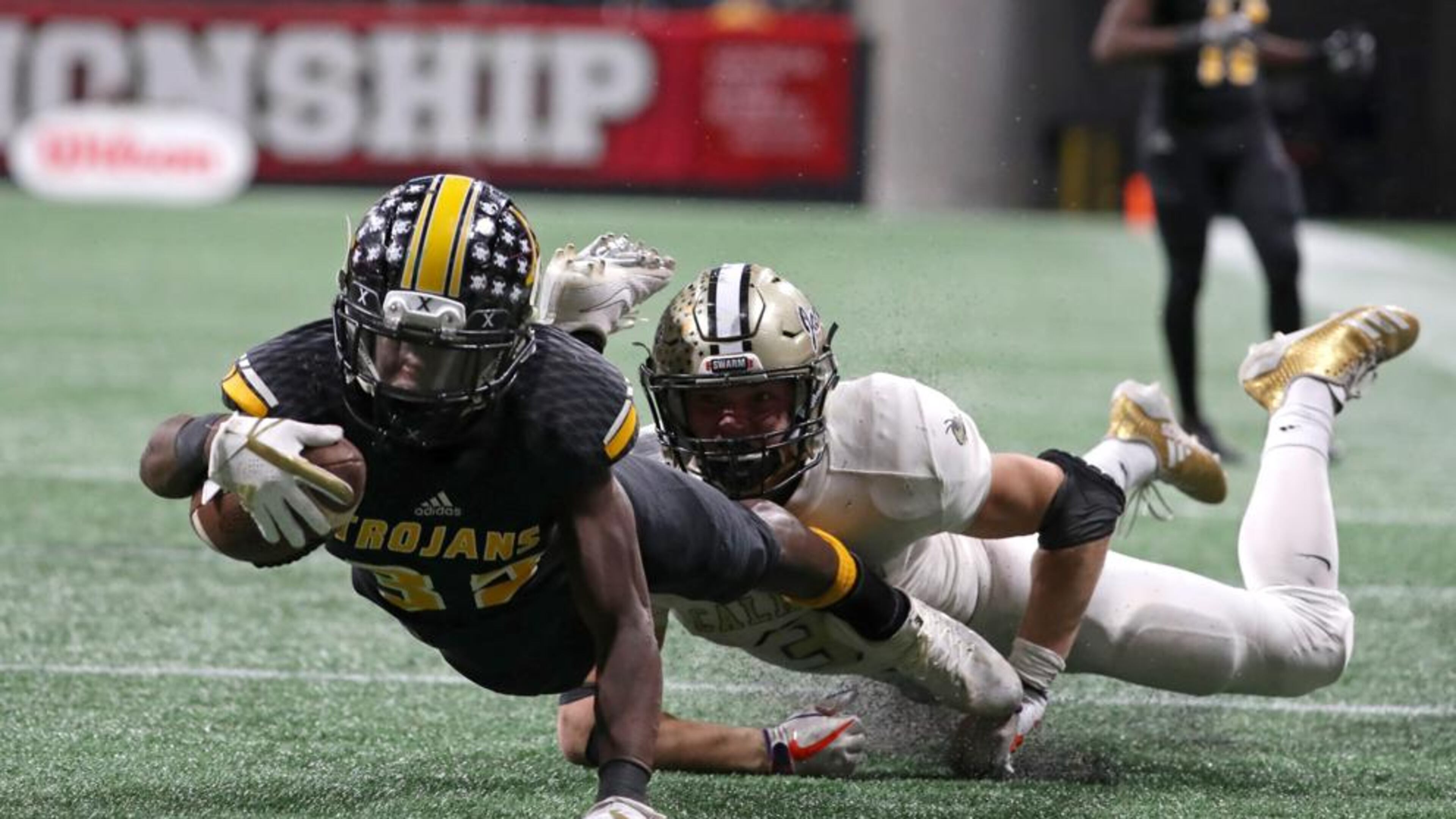 Noah Whittington tackled by Calhoun's Brannon Spector at the end of the Calhoun/Peach County Class AAA title game. Photo: Jason Getz, AJC