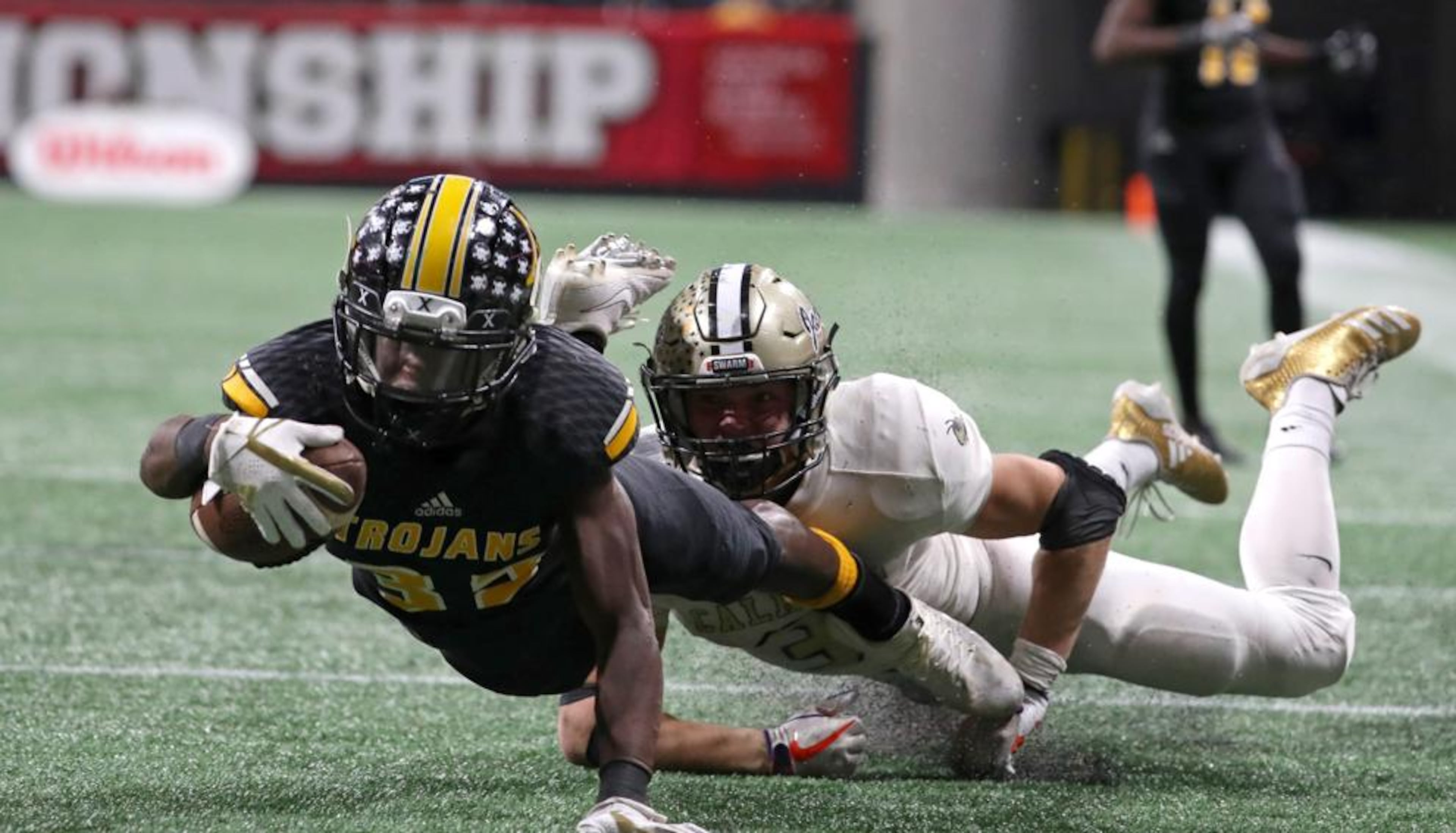 Noah Whittington tackled by Calhoun's Brannon Spector at the end of the Calhoun/Peach County Class AAA title game. Photo: Jason Getz, AJC