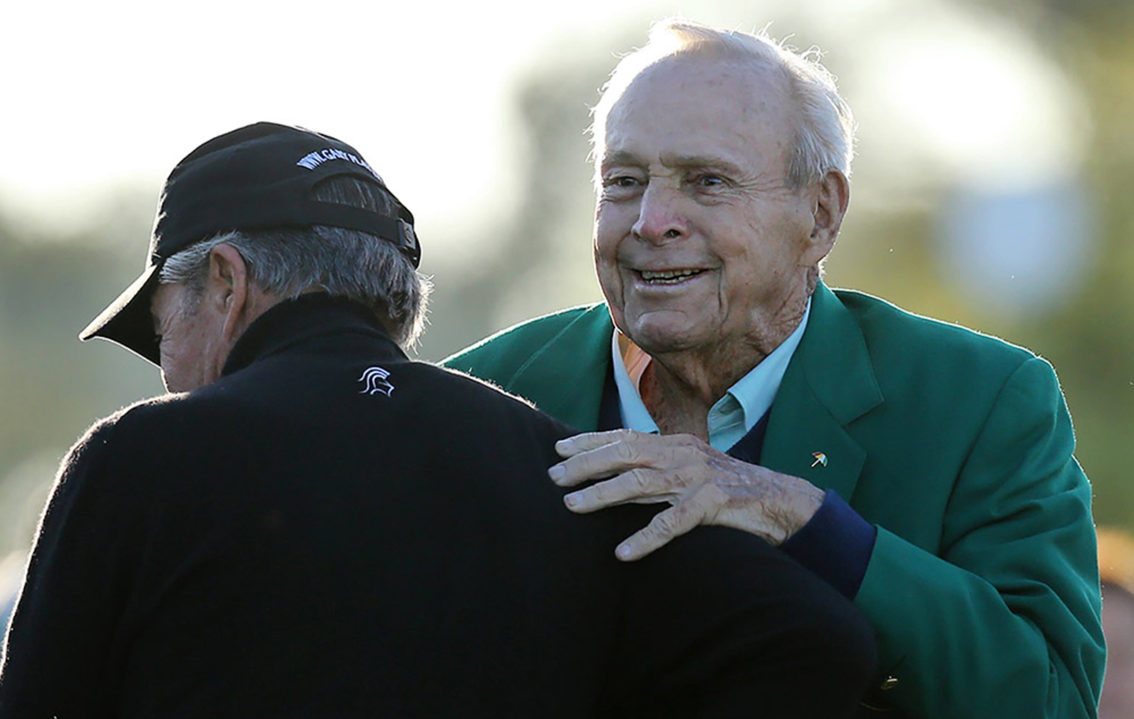 Gary Player gets a hug from Arnold Palmer after hitting his tee shot to begin the Masters at Augusta National Golf Club on Thursday, April 7, 2016, in Augusta.