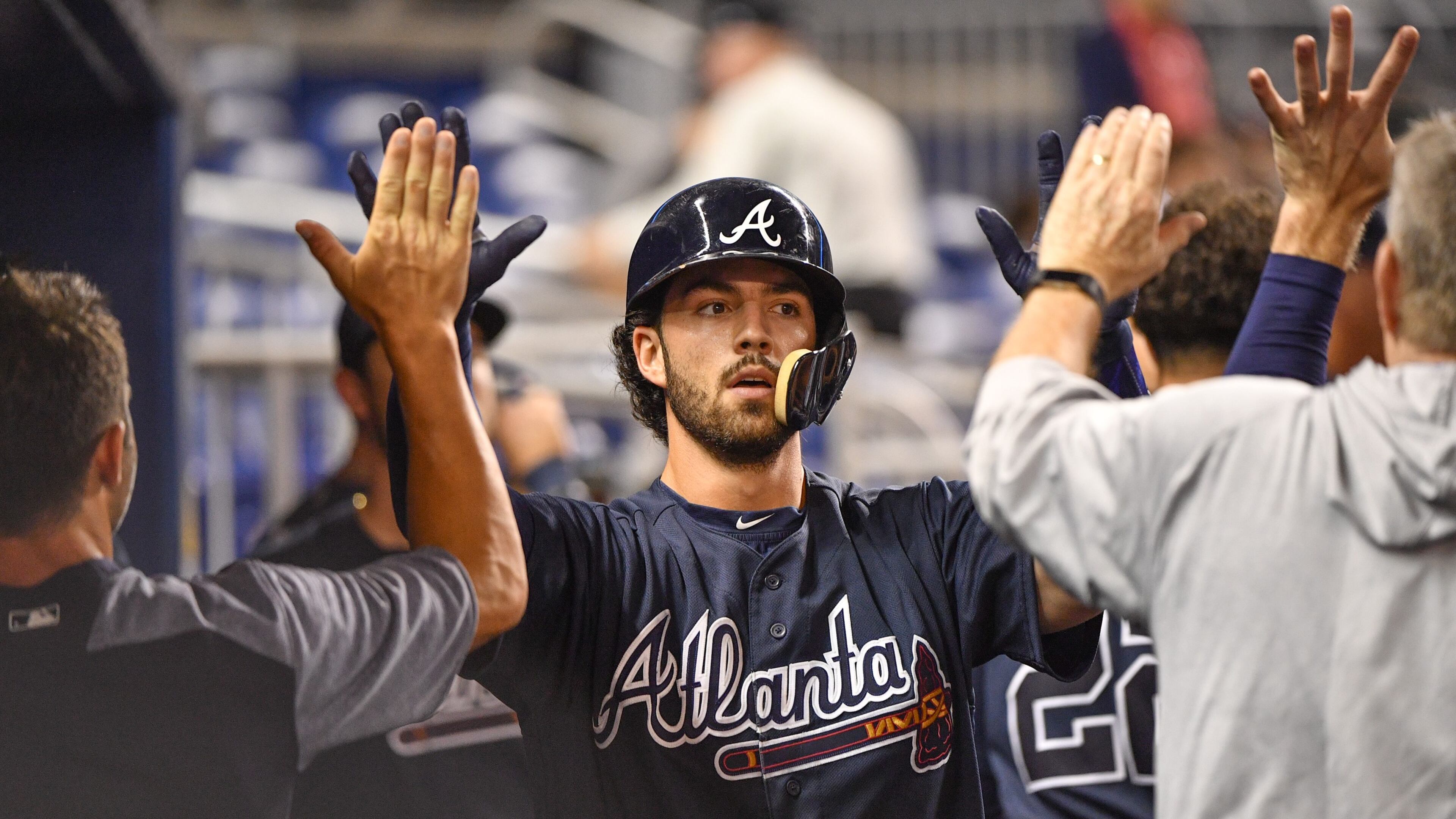 Dansby Swanson of the Atlanta Braves celebrates hitting a homerun with teammates in the dugout during the second inning against the Miami Marlins at Marlins Park on July 23, 2018 in Miami, Florida. (Photo by Mark Brown/Getty Images)