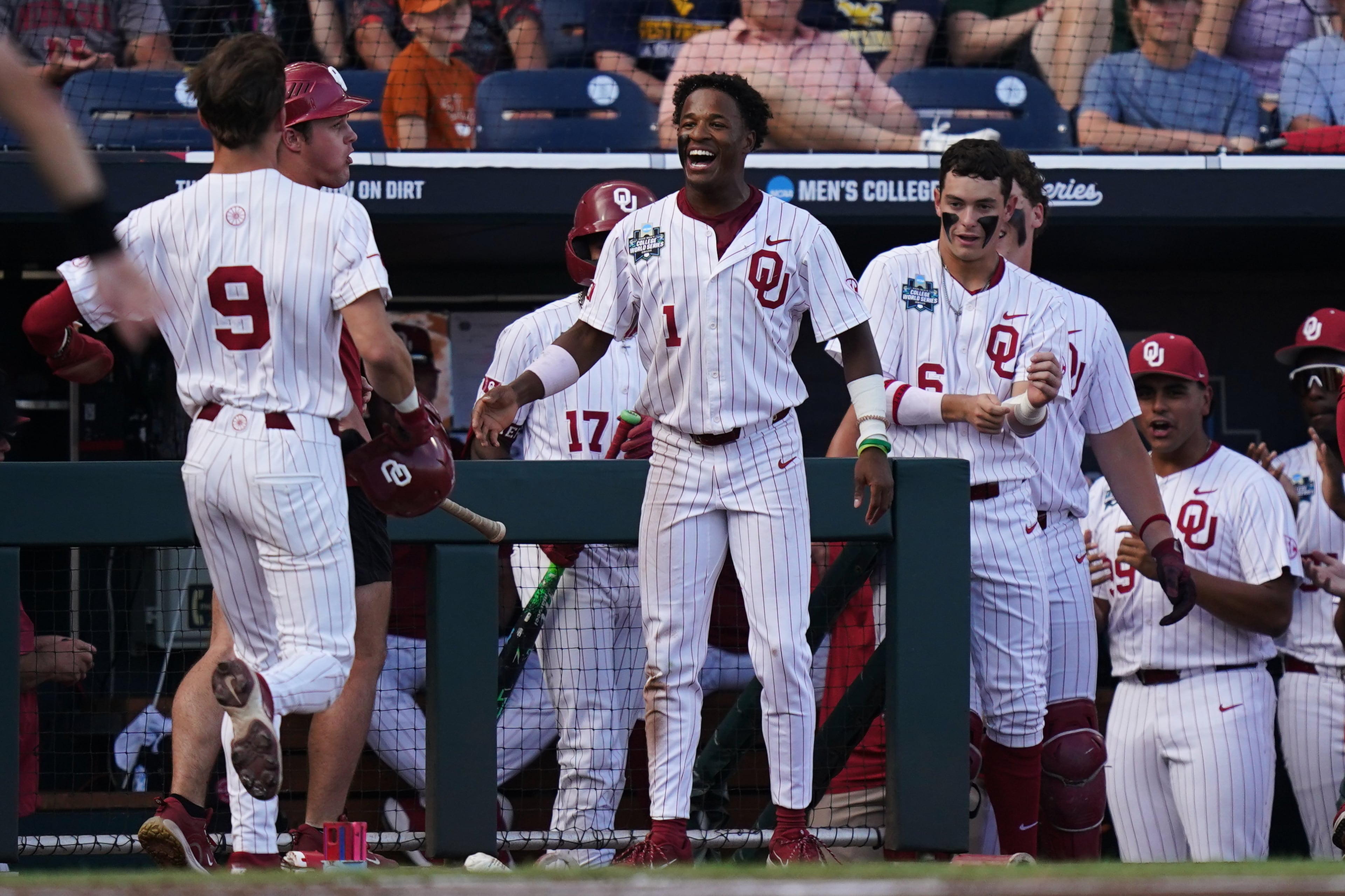 Oklahoma outfielder Jason Walk (center) celebrates with teammates after runs were scored during their College World Series game against Georgia on Monday, June 15, 2026, in Omaha, Neb. Oklahoma won 4-3. (Vera Nieuwenhuis/AP)