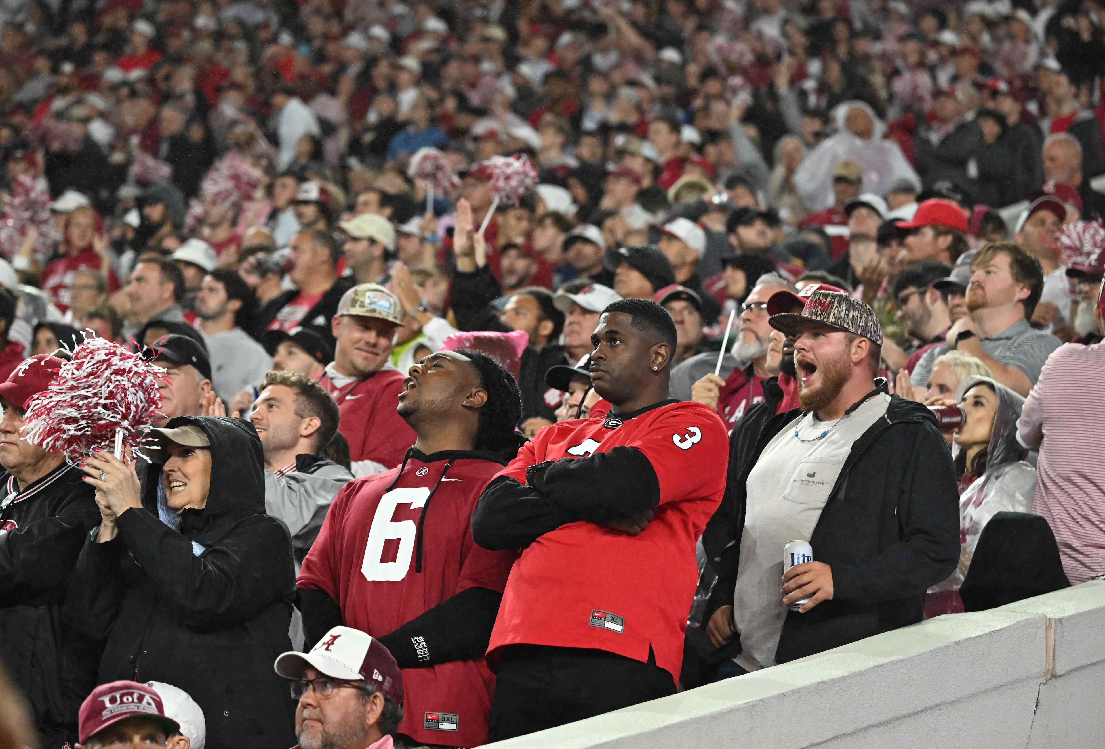 A Georgia fan reacts among Alabama fans during the first half in an NCAA football game at Bryant-Denny Stadium on Saturday, Oct. 10, 2026, in Tuscaloosa, Alabama. (Hyosub Shin/AJC)