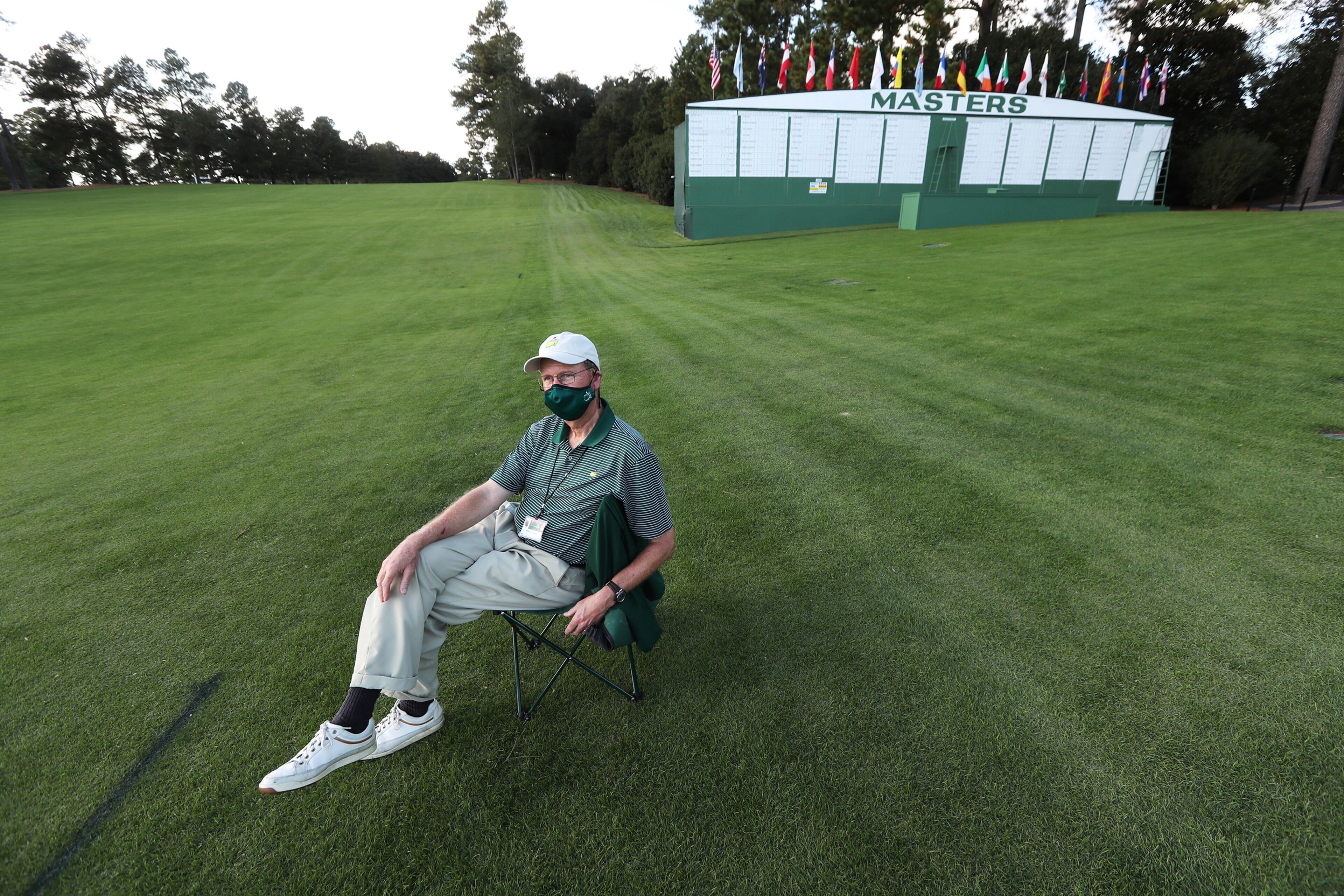 110920 Augusta: — A Tradition Unlike Any Other— In a scene unlike any other at the Masters gallery guard William E. Hardy has the course to himself watching over the first fairway by the giant Masters scoreboard that normally is bustling with patrons snapping photos during the first practice round at Augusta National Golf Club on Monday, Nov 9, 2020, in Augusta. The tournament is being played without patrons. “Curtis Compton / Curtis.Compton@ajc.com”
