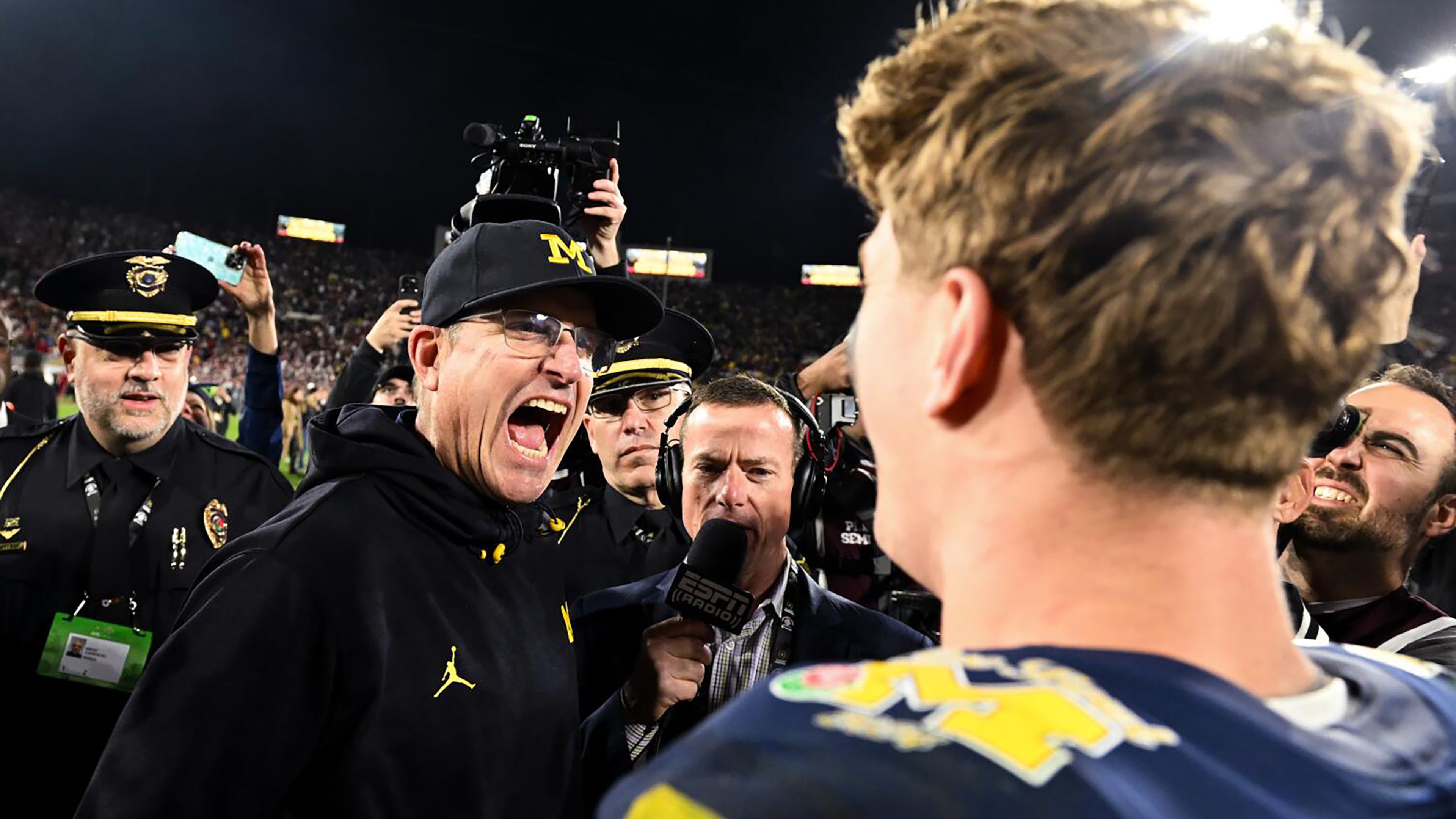 Michigan Wolverines head coach Jim Harbaugh, left, celebrates with quarterback J.J. McCarthy (9) after defeating Alabama 27-20 in overtime of the College Football Playoff semifinals hosted by the Rose Bowl game to advance to the finals at Rose Bowl in Pasadena, California, Monday, Jan. 1, 2024. (Wally Skalij/Los Angeles Times/TNS)