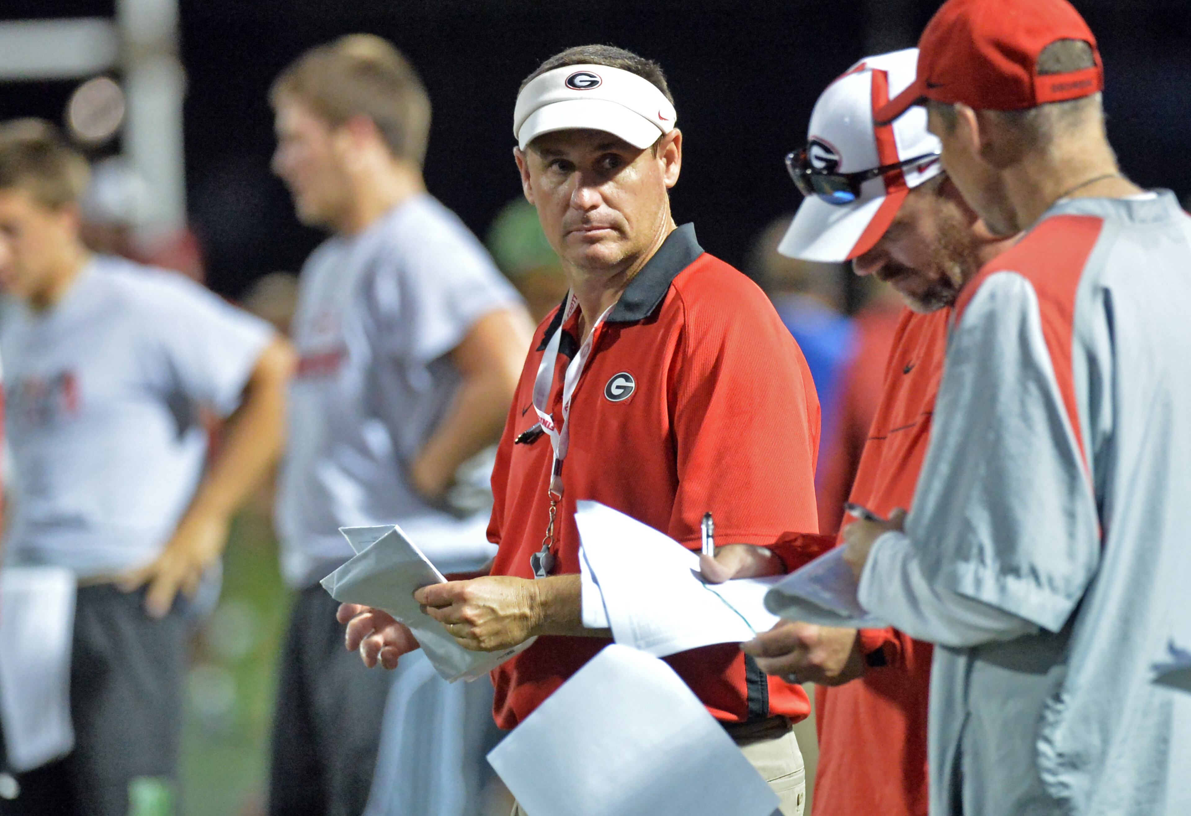 UGA director of on-campus recruiting, Daryl Jones (center) watches during the annual Dawg Night camp at the Butts-Mehre practice fields in UGA Campus in Athens on Friday, July 12, 2013. HYOSUB SHIN / HSHIN@AJC.COM