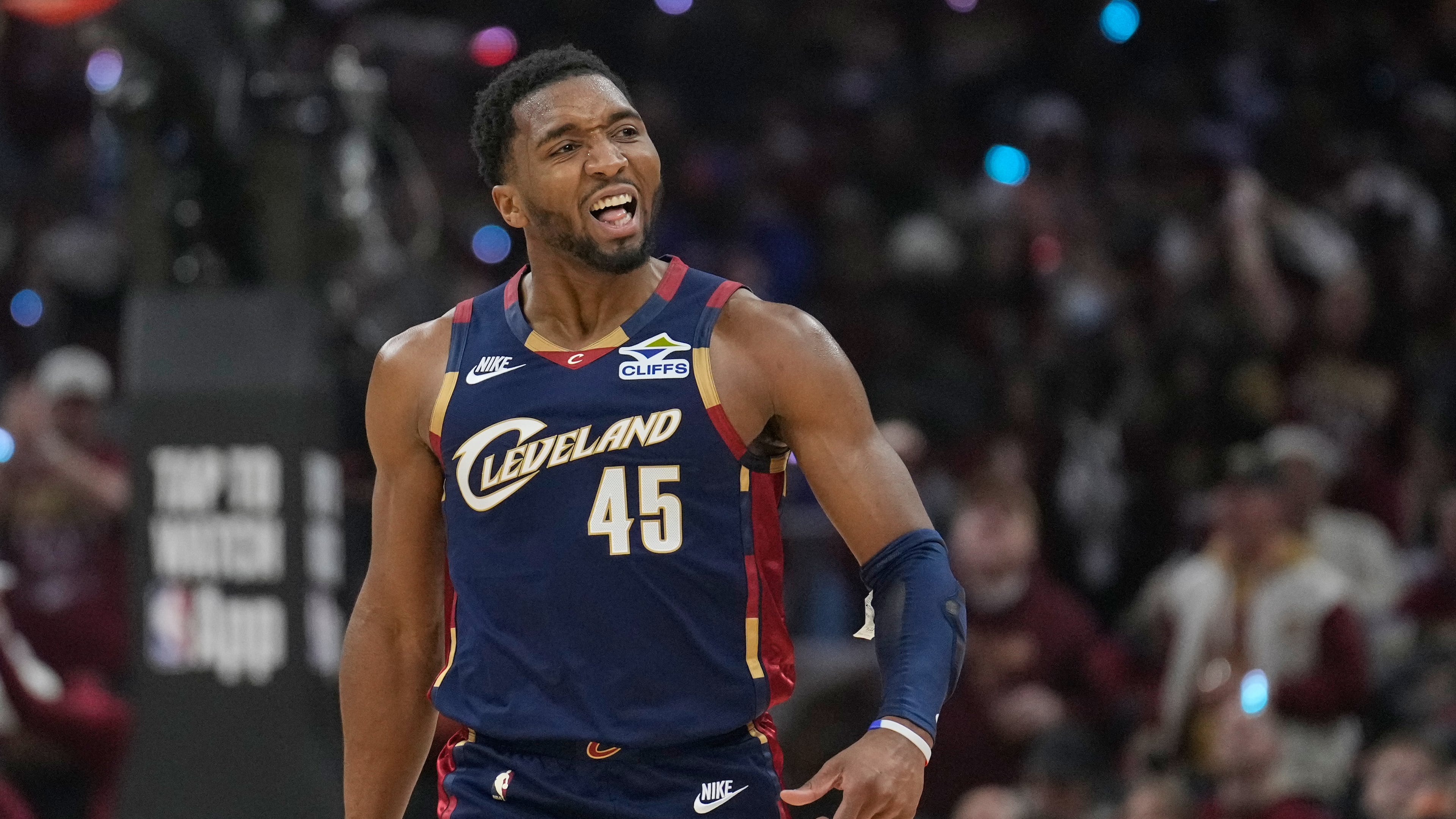 Cleveland Cavaliers guard Donovan Mitchell (45) gestures to the crowd in the first half in Game 2 of a first-round NBA basketball playoffs series against the Toronto Raptors in Cleveland, Monday, April 20, 2026. (AP Photo/Sue Ogrocki)