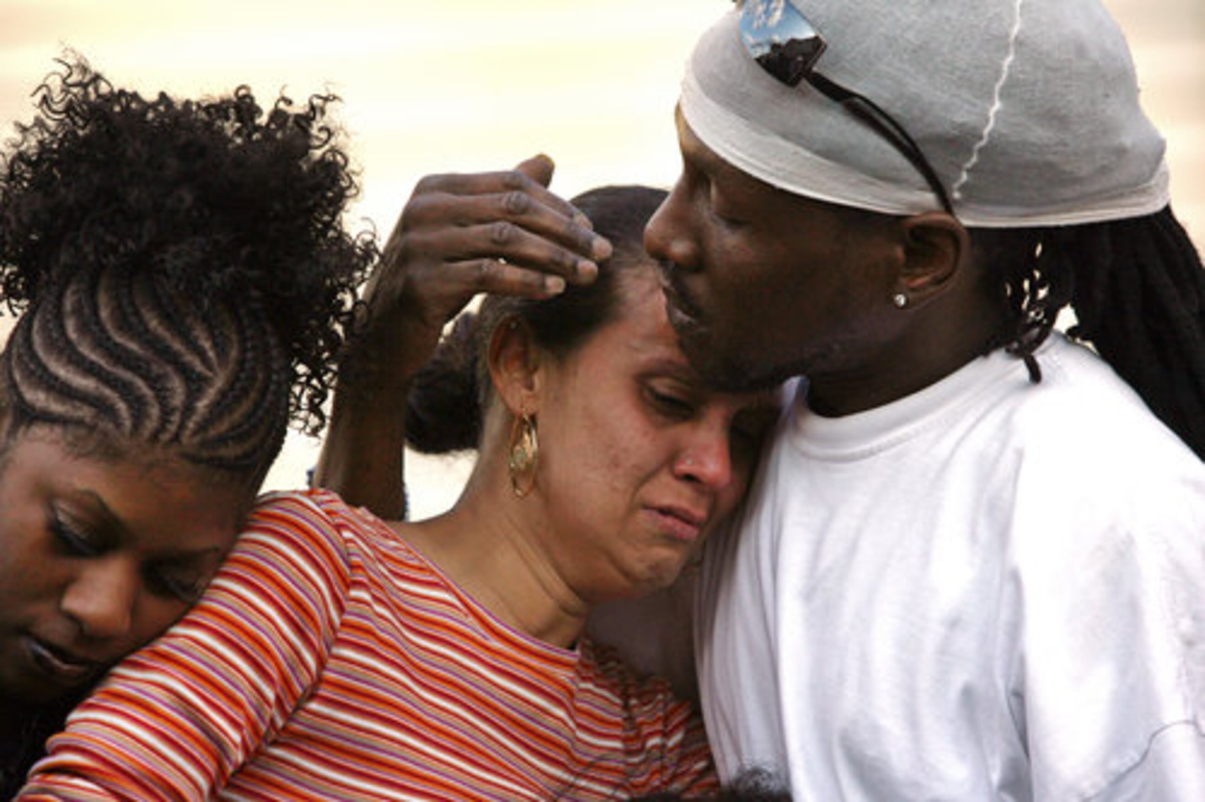 Masika Bermudez is comforted by her husband Norman Keene. As Bermudez spoke, she clung to her daughters " Ny'irah, 7 and Yerralis, 10. Yerralis discovered her brother's body last Thursday after school.
