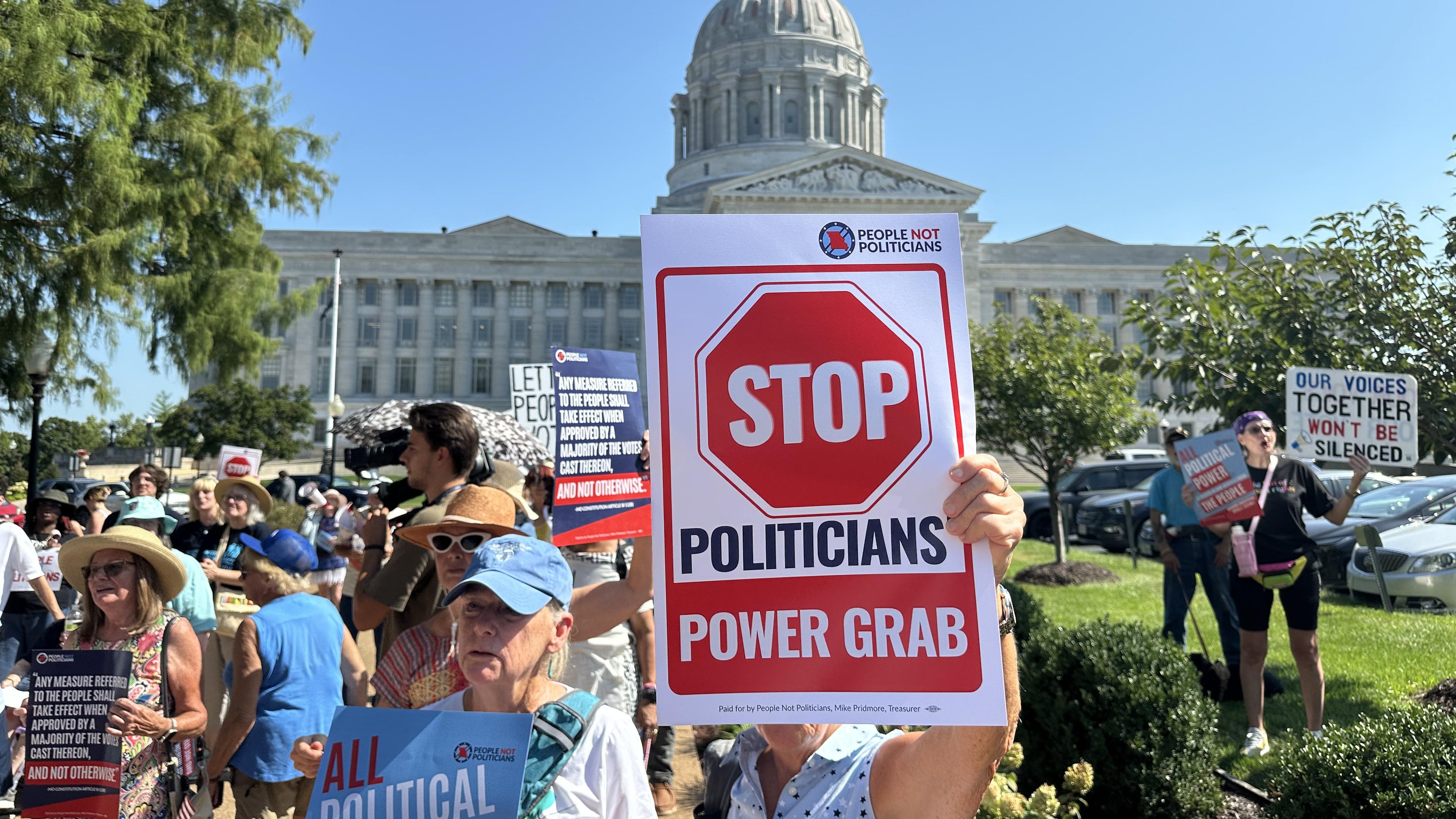 In this photo taken with a smartphone, people opposed to a congressional redistricting plan rally outside the Missouri Capitol in Jefferson City, Mo., Wednesday, Sept. 2, 2026. (AP Photo/David A. Lieb)