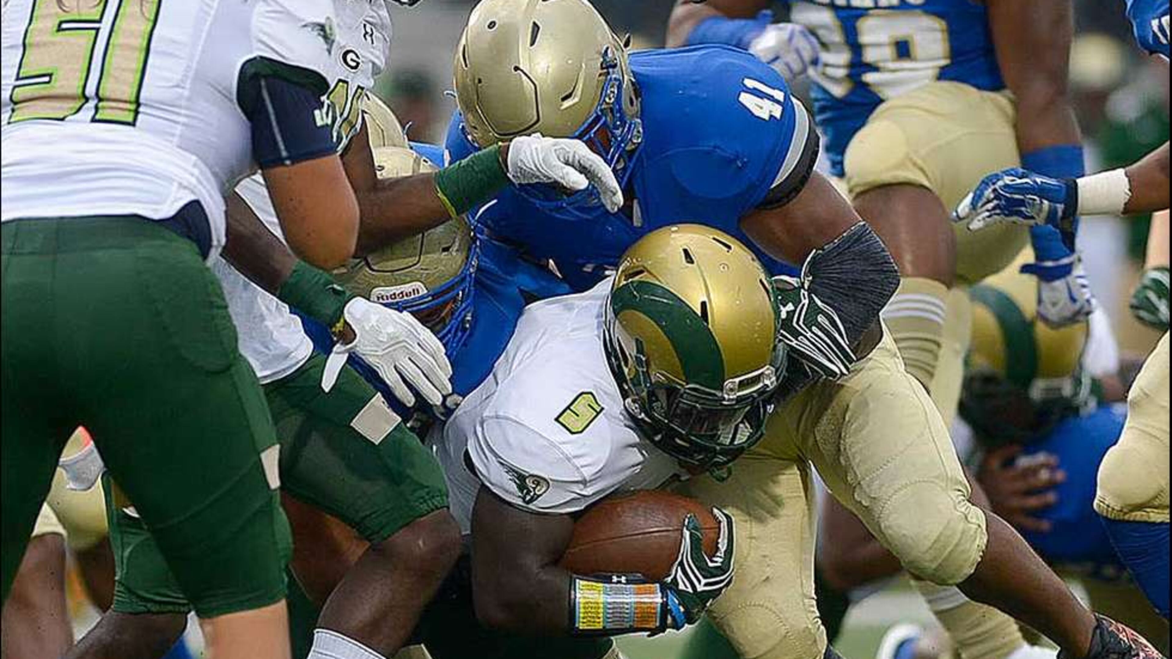 Grayson senior Kurt Taylor (5) powers through a tackle by McEachern senior LB Quentin Hayes (41) during Friday's game. Daniel Varnado/Special