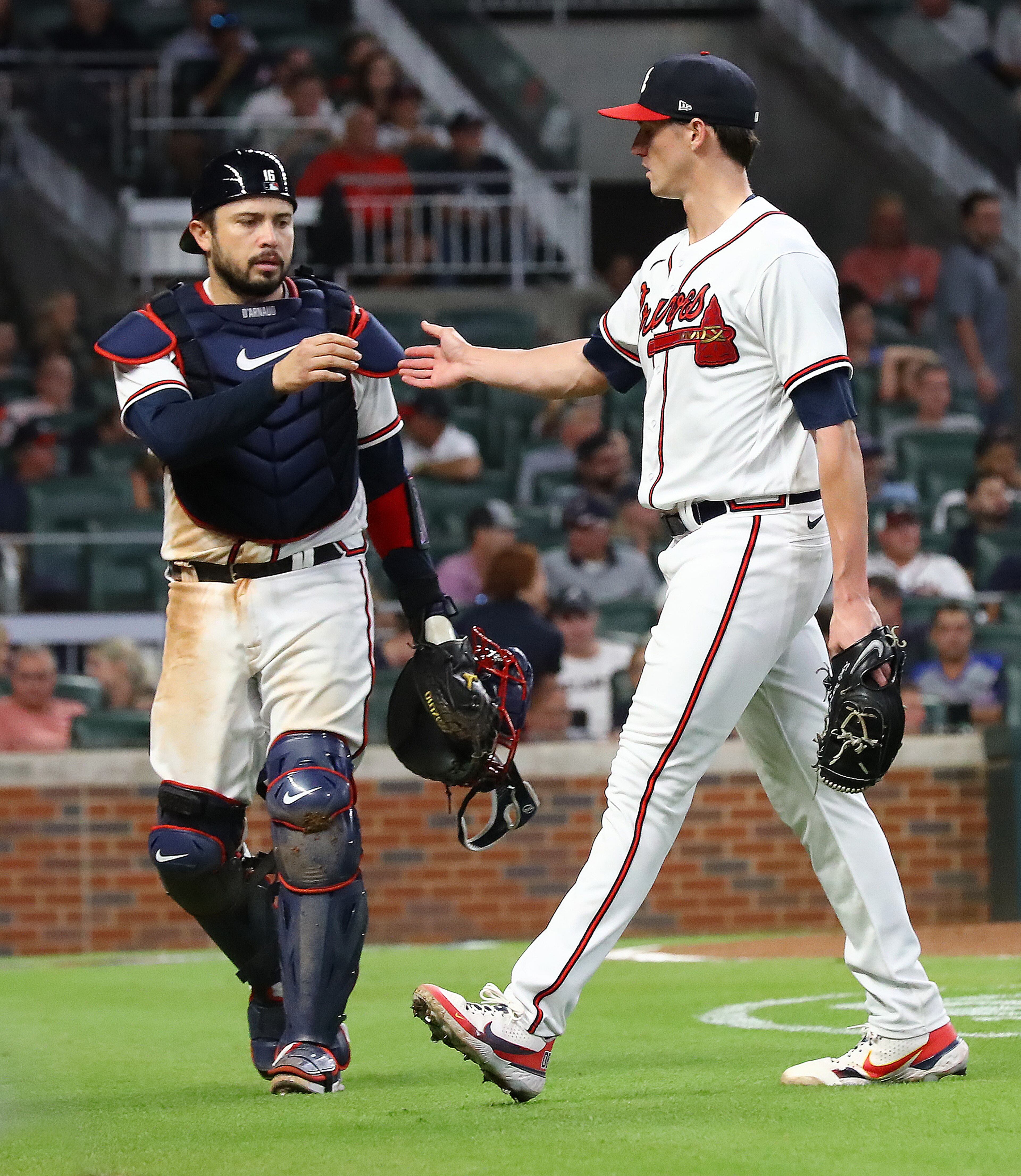 Braves starting pitcher Kyle Wright gets five from catcher Travis d'Arnaud after Wright went six innings against the Nationals on Monday night at Truist Park. (Curtis Compton / Curtis Compton@ajc.com)