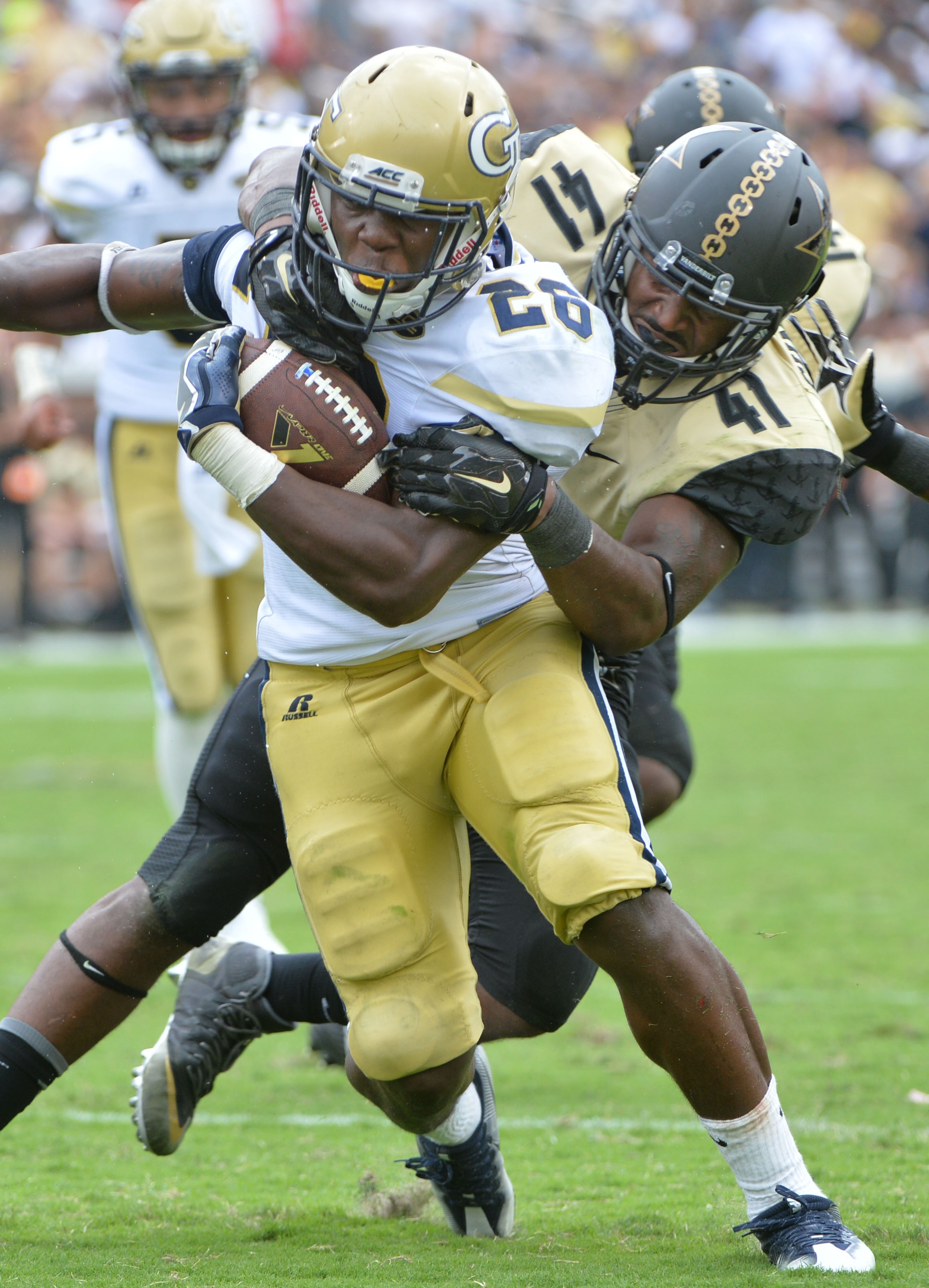 September 17, 2016 Atlanta - Georgia Tech Yellow Jackets running back Dedrick Mills (26) breaks away for a touchdown as Vanderbilt Commodores linebacker Zach Cunningham tries to stop him in the second half at Bobby Dodd Stadium on Saturday, September 17, 2016. Georgia Tech Yellow Jackets won 38-7 over the Vanderbilt Commodores. HYOSUB SHIN / HSHIN@AJC.COM