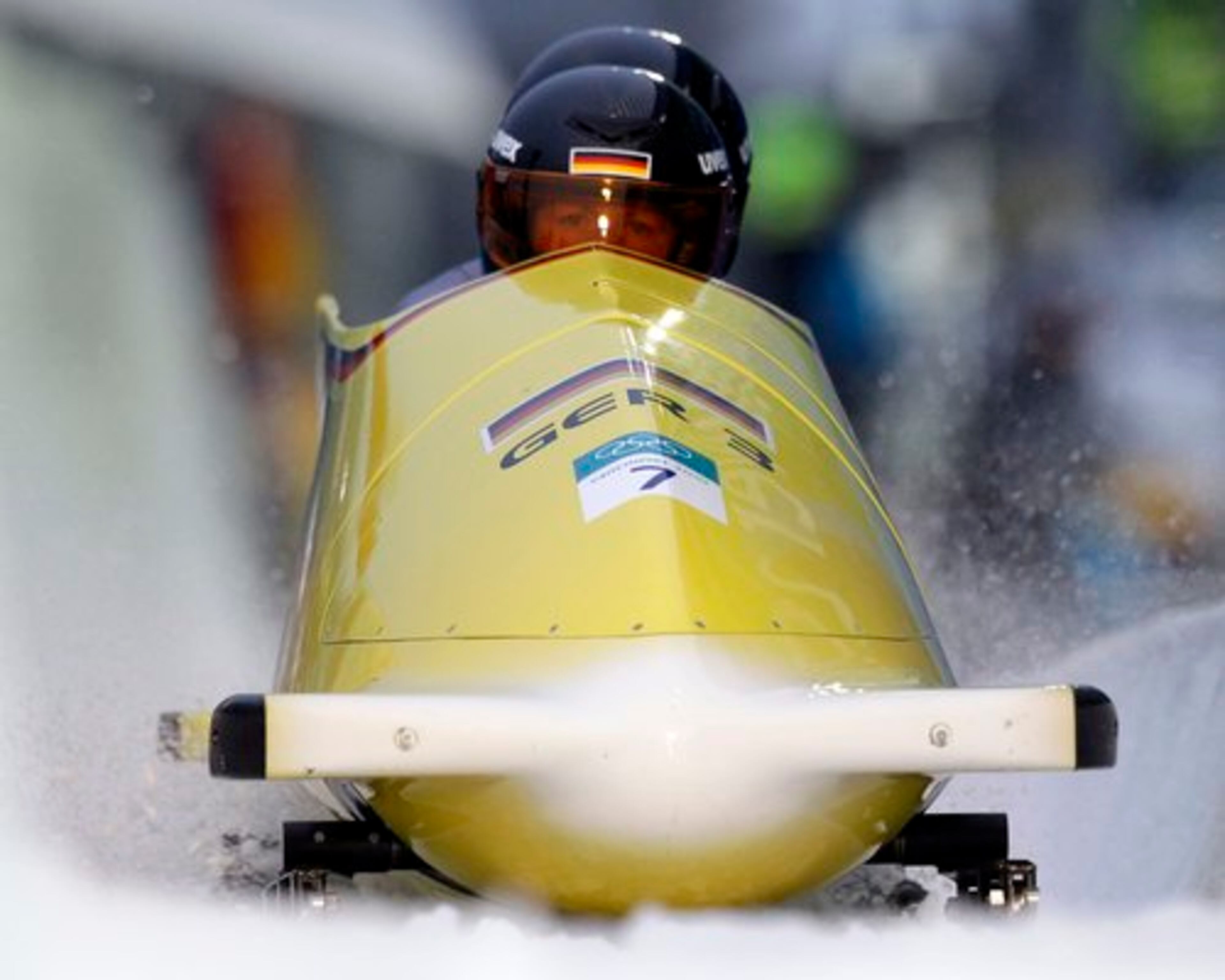 Germany's GER-3, piloted by Claudia Schramm, fronbt, with brakeman Janine Tischer, brake in the finish area after the third run.