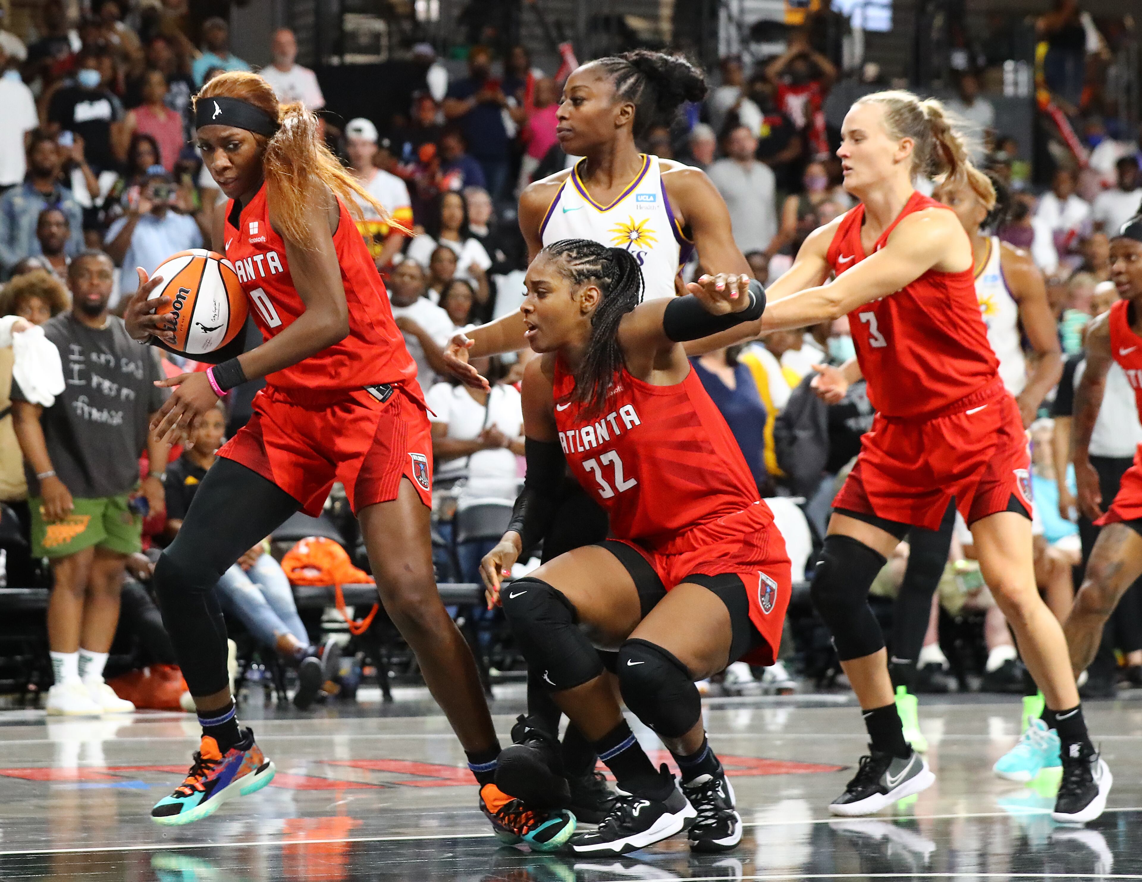 051122 College Park: Atlanta Dream guard Rhyne Howard (from left) takes the rebound away from Los Angeles Sparks forward Chiney Ogwumike with help from Cheyenne Parker and Kristy Wallace in the final seconds to hold on to a 77-75 victory in the home opener of a WNBA basketball game on Wednesday, May 11, 2022, in College Park. “Curtis Compton / Curtis.Compton@ajc.com”