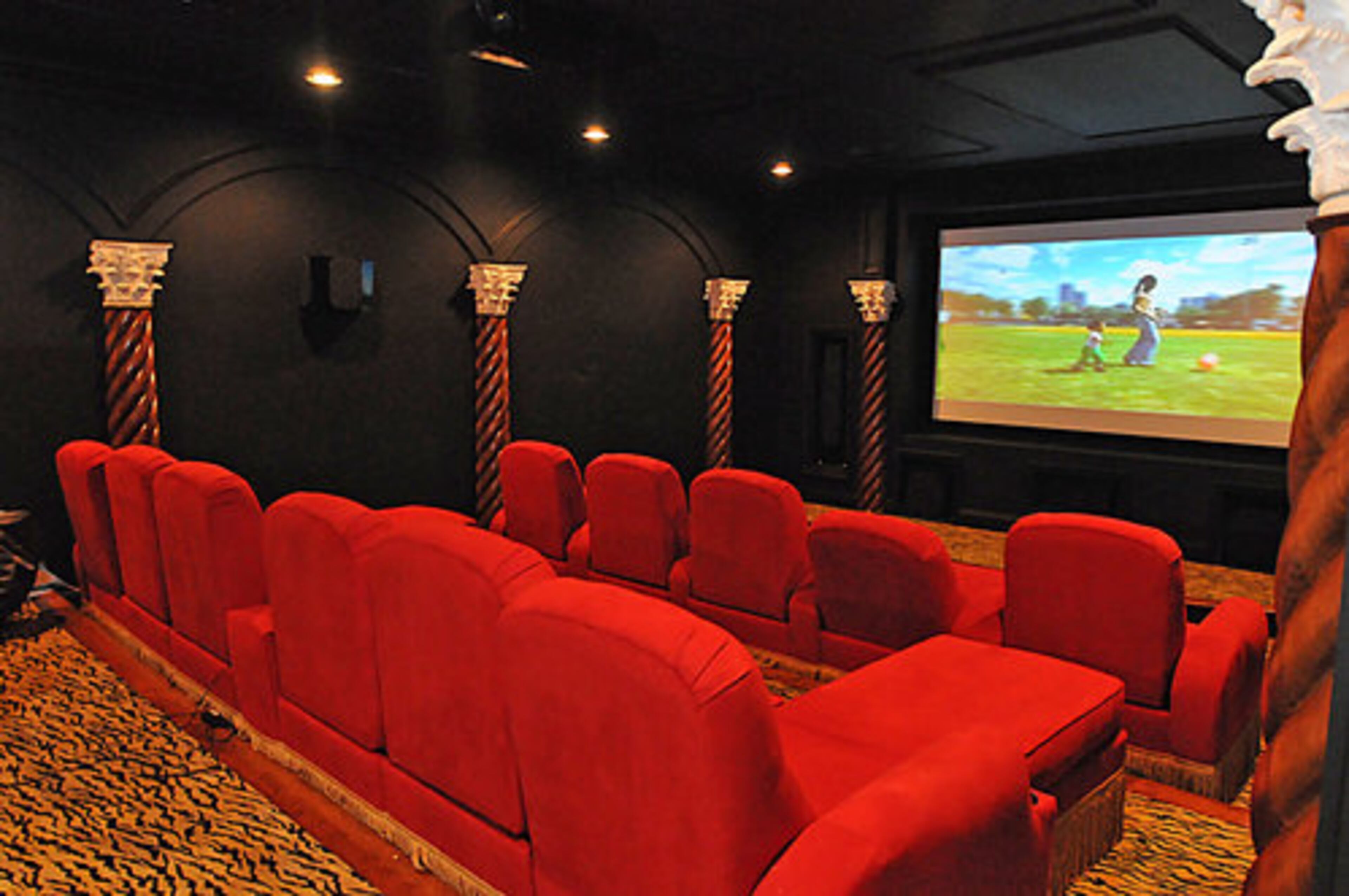 The state-of-the-art home theater features plush red stadium-style seating, theater-style decor and the highest quality in home audio and video.