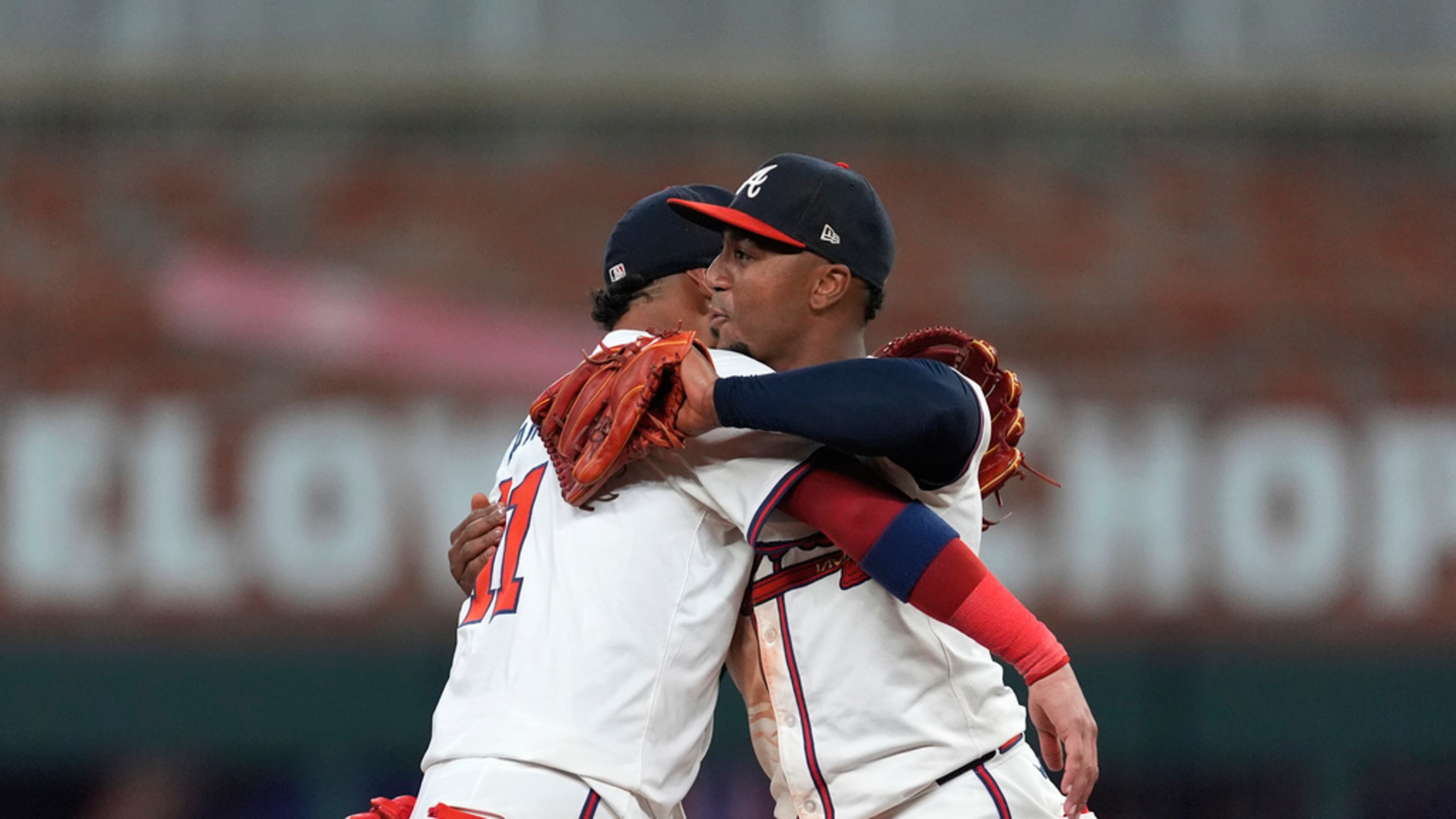 Atlanta Braves second base Ozzie Albies, right, and shortstop Orlando Arcia celebrate after defeating Detroit Tigers in a baseball game Tuesday, June 18, 2024, in Atlanta. (AP Photo/John Bazemore)