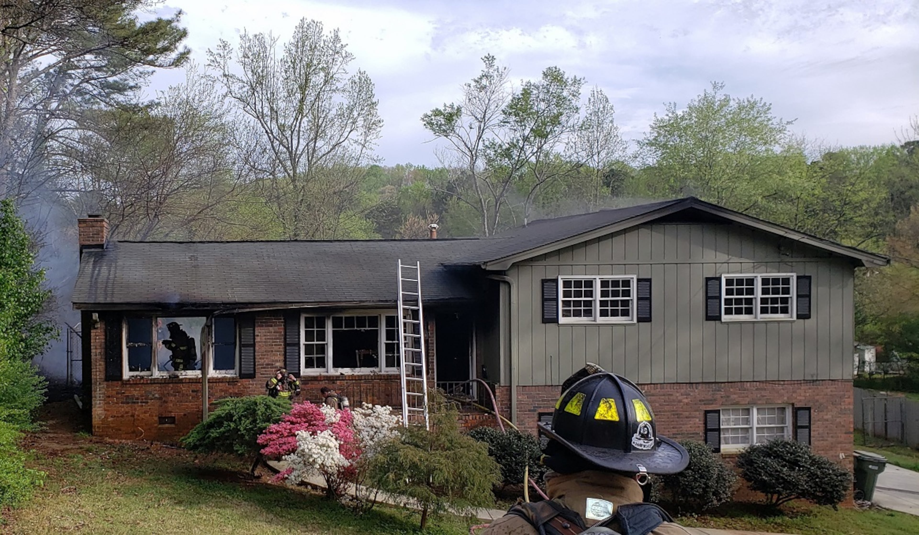 The 911 caller reported that there were flames bursting through the windows and the roof before firefighters arrived.