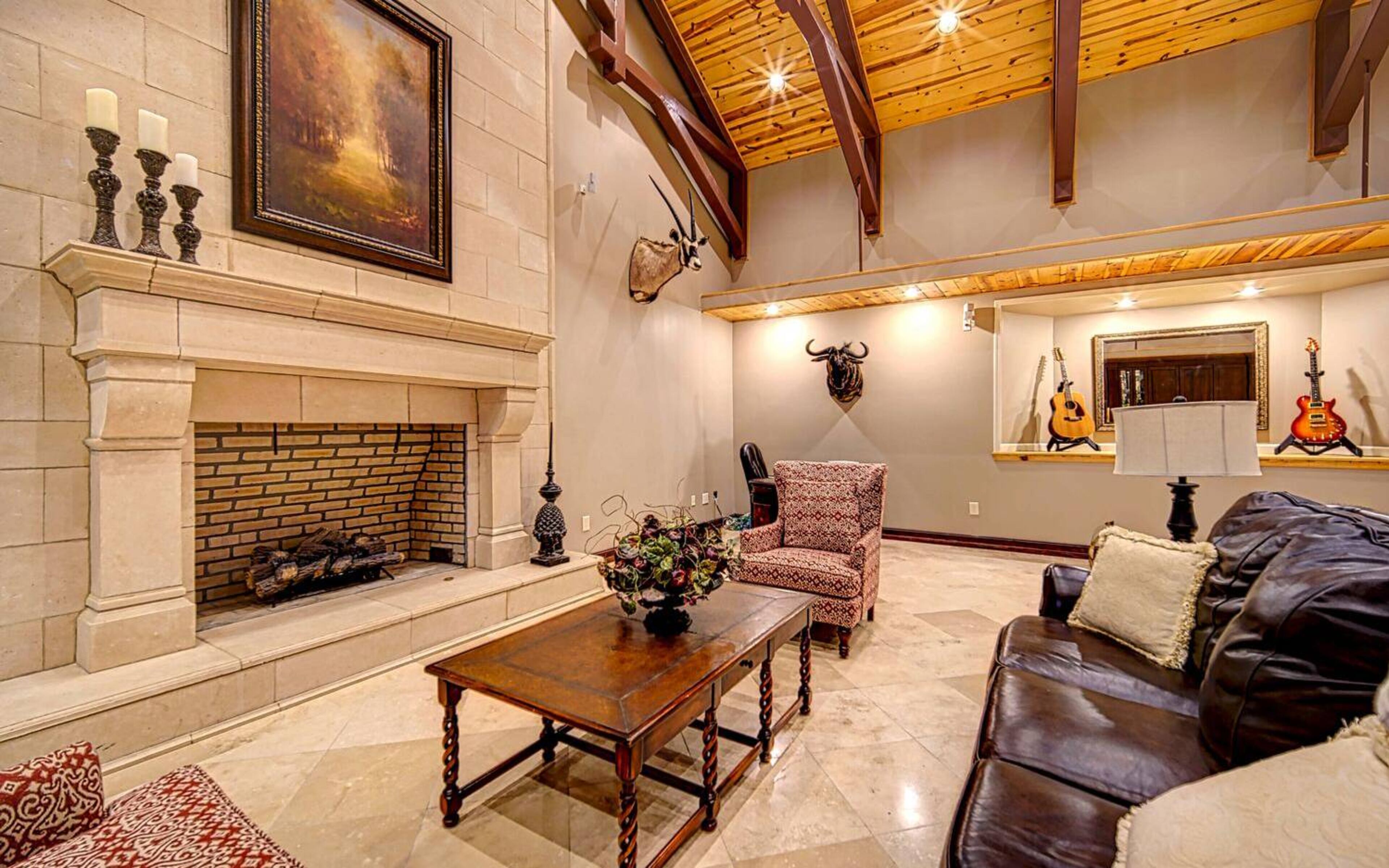 High wood-beam ceilings with fireplace.