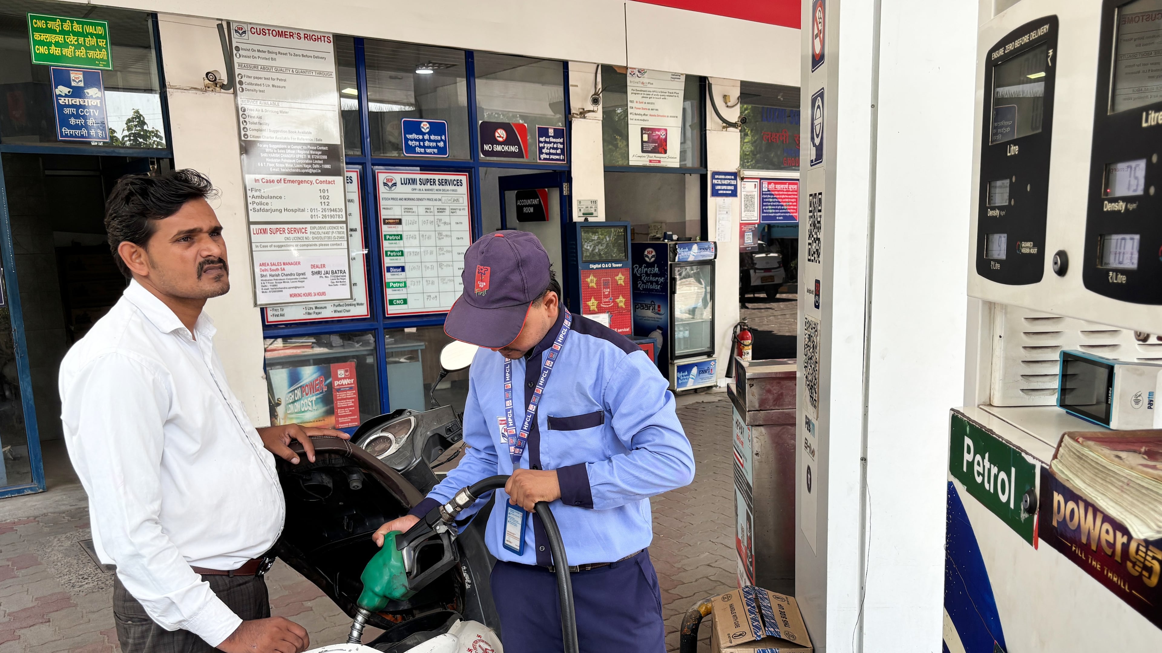 A commuter monitors the meter as an attendant refuels his scooter at a filling station in New Delhi, India, Friday, May 15, 2026. (AP Photo/Shonal Ganguly)