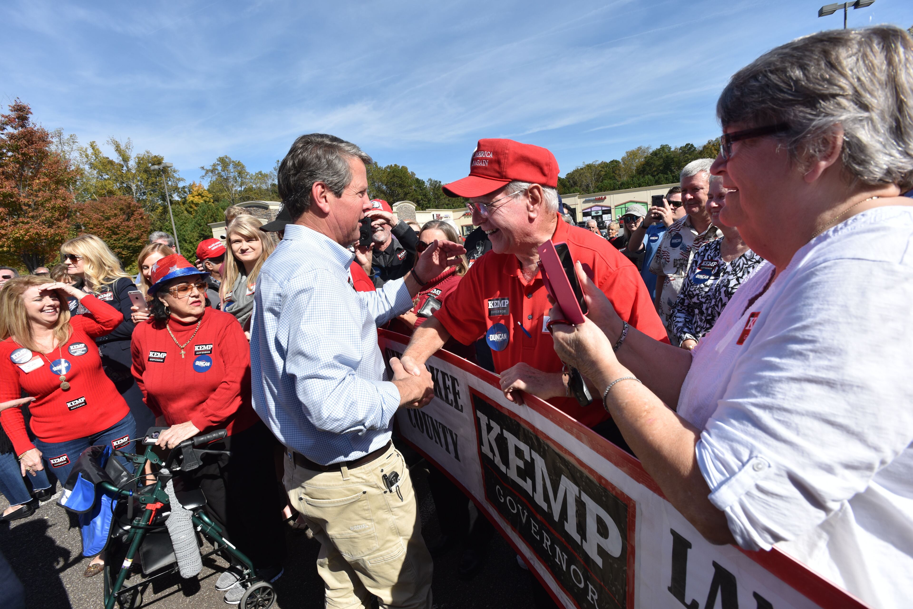 October 30, 2018 Woodstock - GOP gubernatorial candidate Brian Kemp is greeted by supporter Conrad Quagliaroli at Streetside At Towne Lake shopping mall in Woodstock during The Georgia Republican Party "Road to Victory" Bus Tour on Tuesday, October 30, 2018. Brian Kemp's stops in Cumming and Woodstock attracted hundreds of voters. Democrats have put a bullseye on the close-in suburbs, which were once solidly conservative but transformed into swingier territory with Donald Trumpâs victory. HYOSUB SHIN / HSHIN@AJC.COM