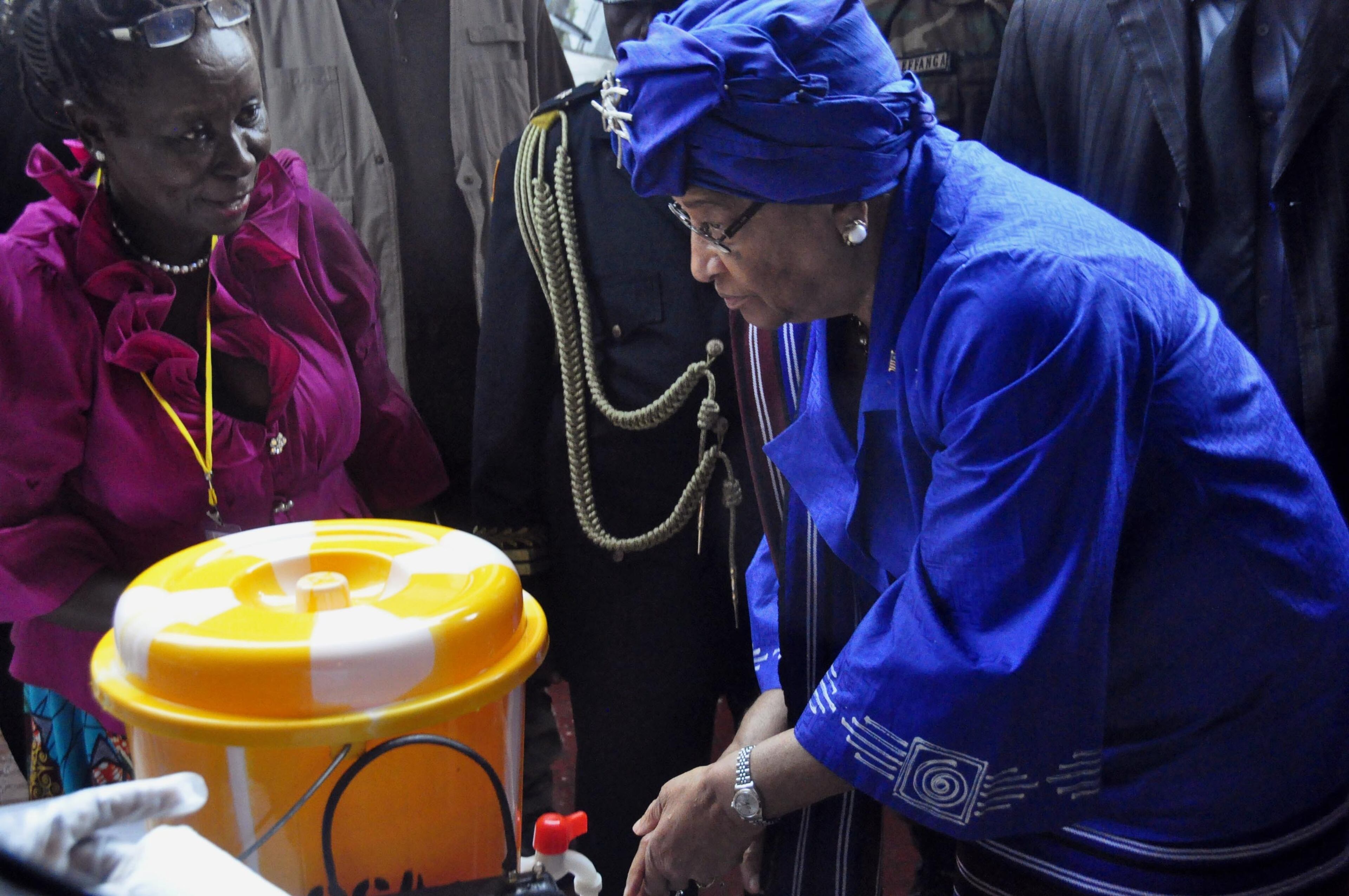 Ellen Johnson Sirleaf is the current president of Liberia and the first elected female head of state in Africa. She won the 2011 Nobel Peace Prize. In this photo taken on Saturday, July 26, 2014, Liberia President Ellen Johnson Sirleaf, right, demonstrates to people how to wash their hands properly in order to prevent the spread of the Ebola virus, during Independence Day celebrations in the city of Monrovia, Liberia. (AP Photo/Abbas Dulleh)
