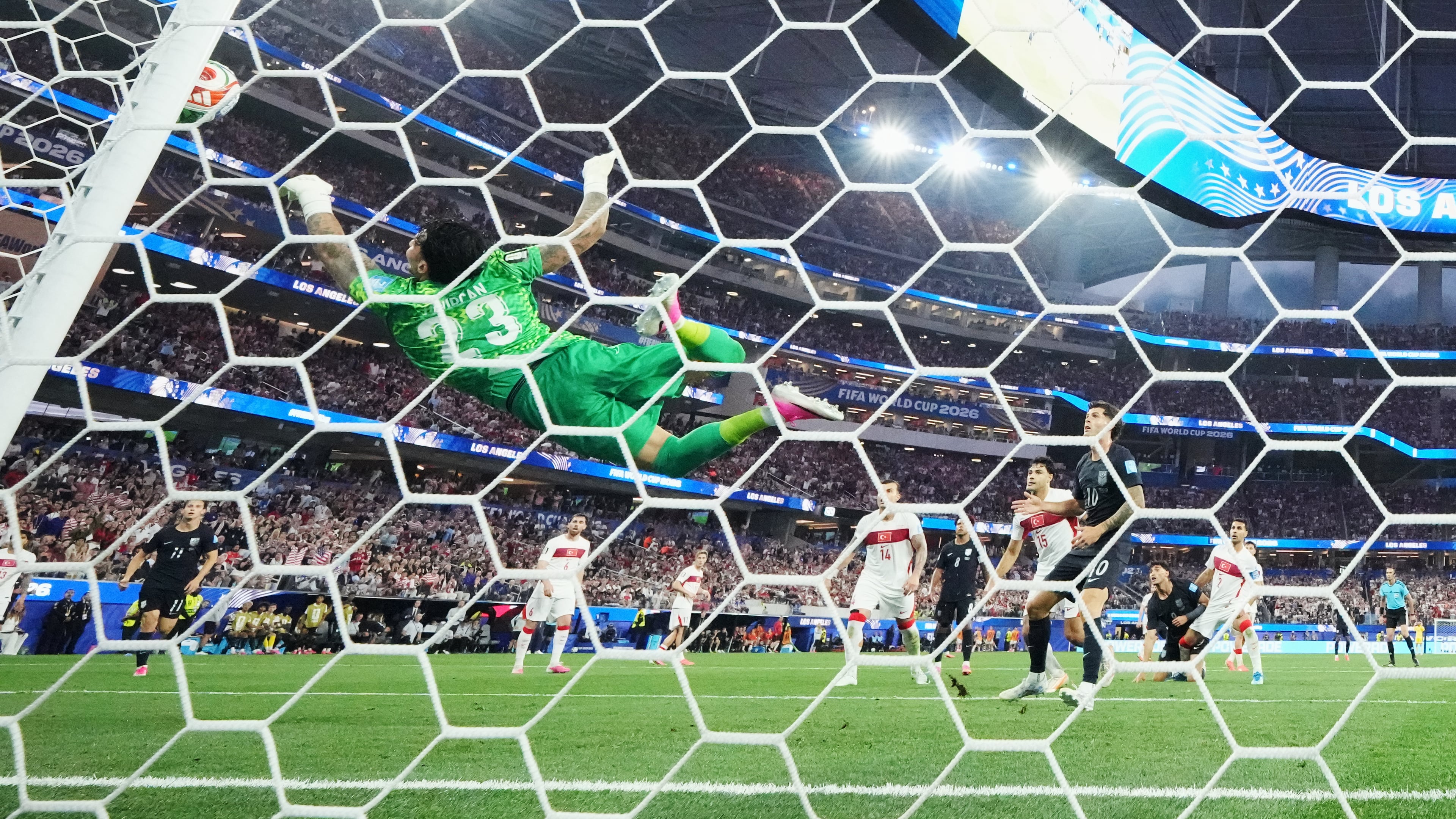 Tunisia's Moutaz Neffati (23) makes a diving save on a shot by United States' Christian Pulisic (10) during the World Cup Group D soccer match between Turkey and the United States in Inglewood, Calif., near Los Angeles, Thursday, June 25, 2026. (AP Photo/Andre Penner)