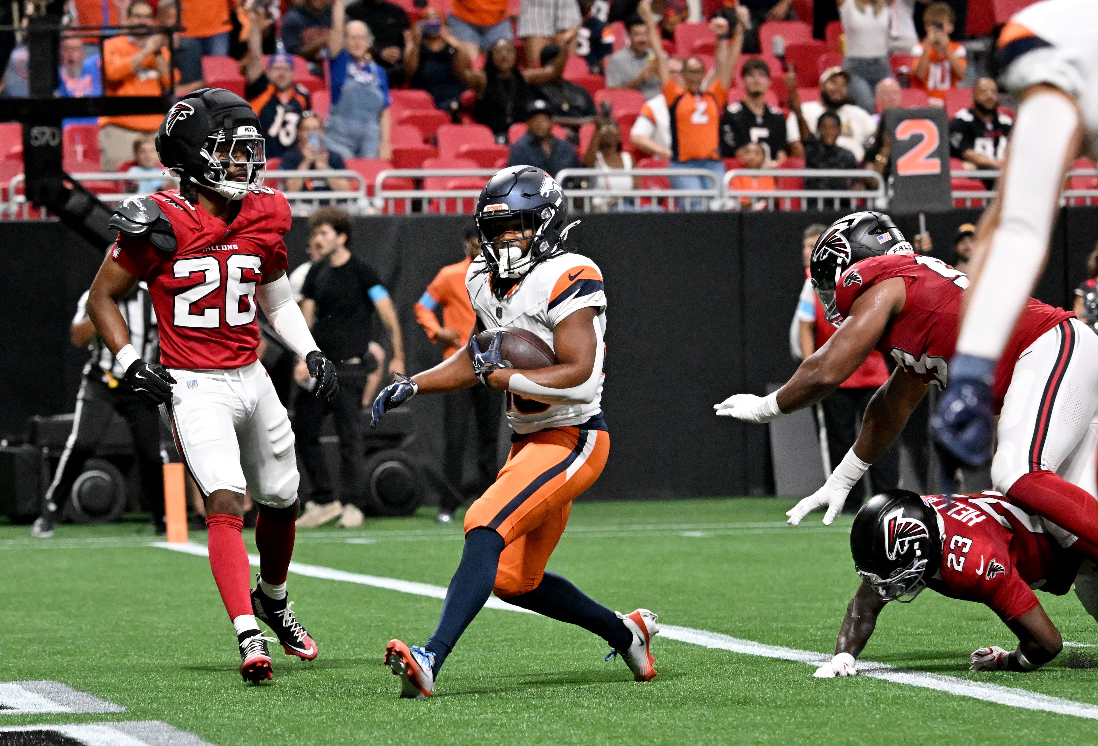Broncos running back Jaleel McLaughlin (center) scores a touchdown during the first half of their preseason game against the Falcons at Mercedes-Benz Stadium on Friday, Aug. 14, 2026, in Atlanta. (Hyosub Shin/AJC)