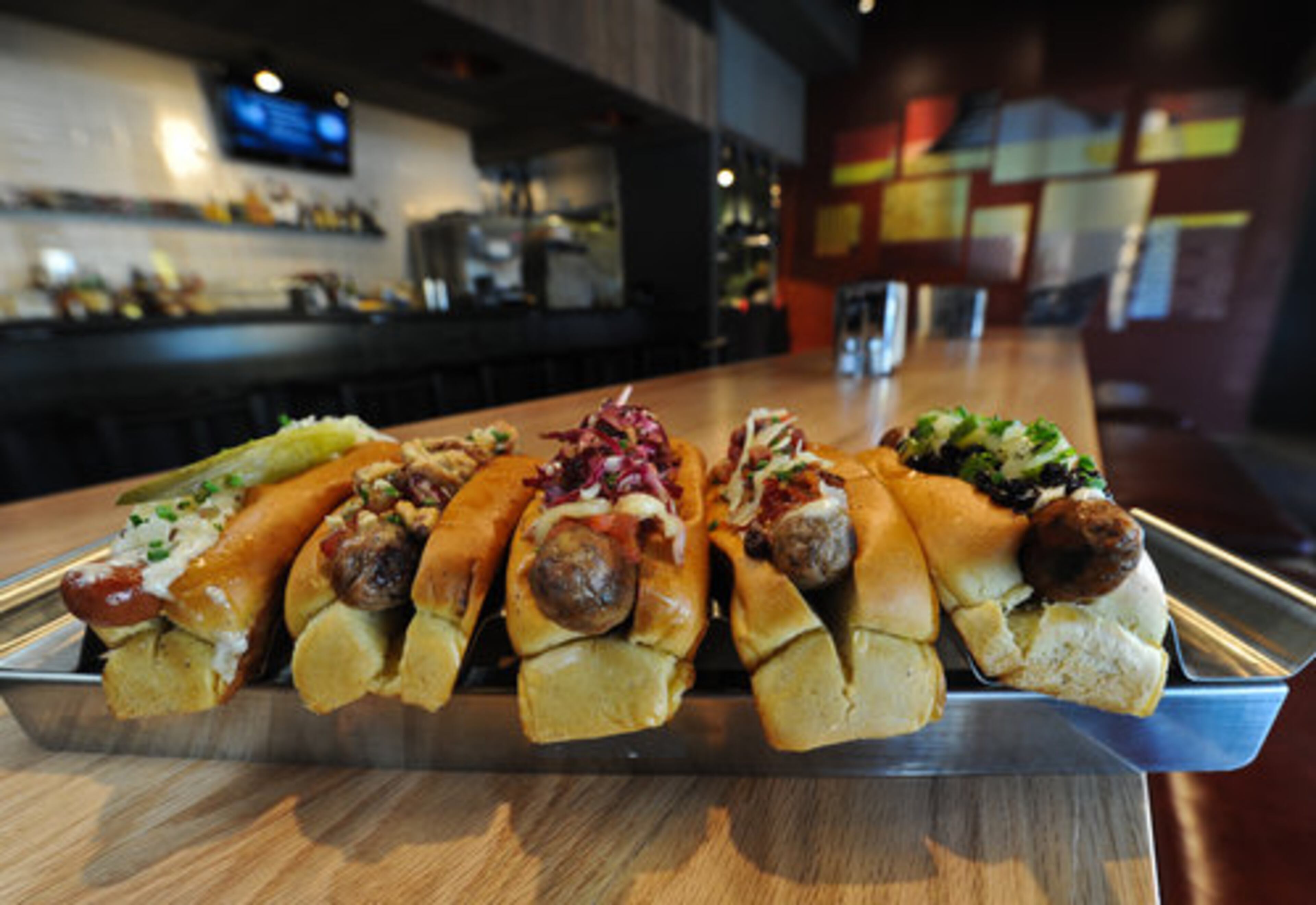 Reuben dog (from left), chicken-apple dog, tuscan dog, Kenturkey dog and Merquez dog at HD1 in Atlanta. John Kessler writes, "When you order a hot dog, are you the lone-wiggle-of-mustard kind of garnisher or more of a chili-cheese-slaw-Russian-dressing sort? If you're the latter, then prepare to have a blast exploring the menu at HD1, where the dogs come piled to nose-engulfing heights with garnishes you would never have before imagined." Two stars.