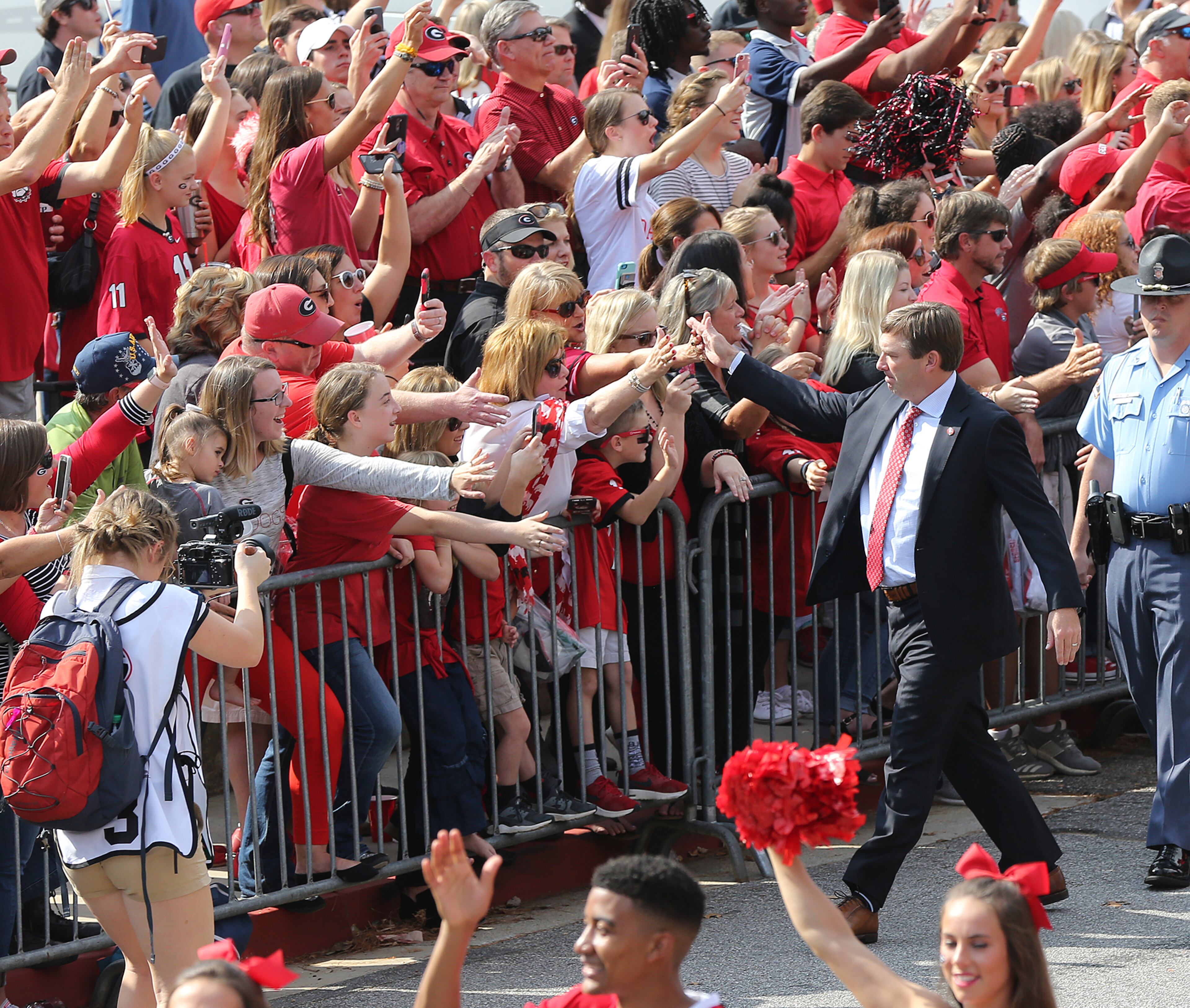 November 4, 2017 Athens: Georgia head coach Kirby Smart high fives fans during the team Dawg Walk into Sanford Stadium to play South Carolina in a NCAA college football game on Saturday, November 4, 2017, in Athens. Curtis Compton/ccompton@ajc.com