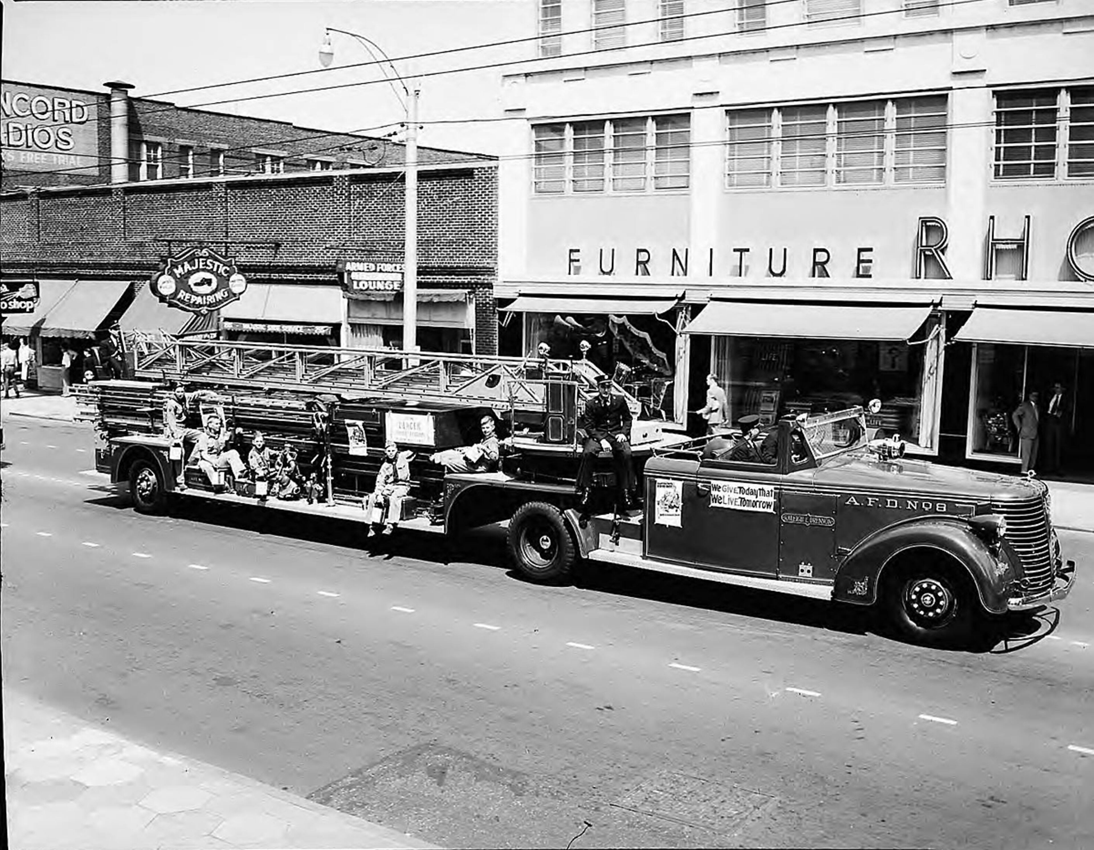 In 1927, the Majestic Hotel was demolished and the shoe repair business, keeping the Majestic name, relocated up the street to 224 Peachtree (across the street from today's Peachtree Center). Also around that time, Tourial sold the business to a man named Sam Epstein. The business would remain within the Epstein family for at least six more decades. Billy Epstein, Sam Epstein's son, recalls that his father was dedicated to hiring quality craftsmen, and that the store was known for dying shoes as well. After WWII, the store created specialty orthopedic shoes for veterans with foot and leg injuries. In 1950, the Majestic Shoe Repair moved a few doors down to 255 Peachtree Street, where it was practically next door to the Rhodes Furniture store, as seen here in 1951. (Lane Brothers, GSU Archives LBCE1-016a)
