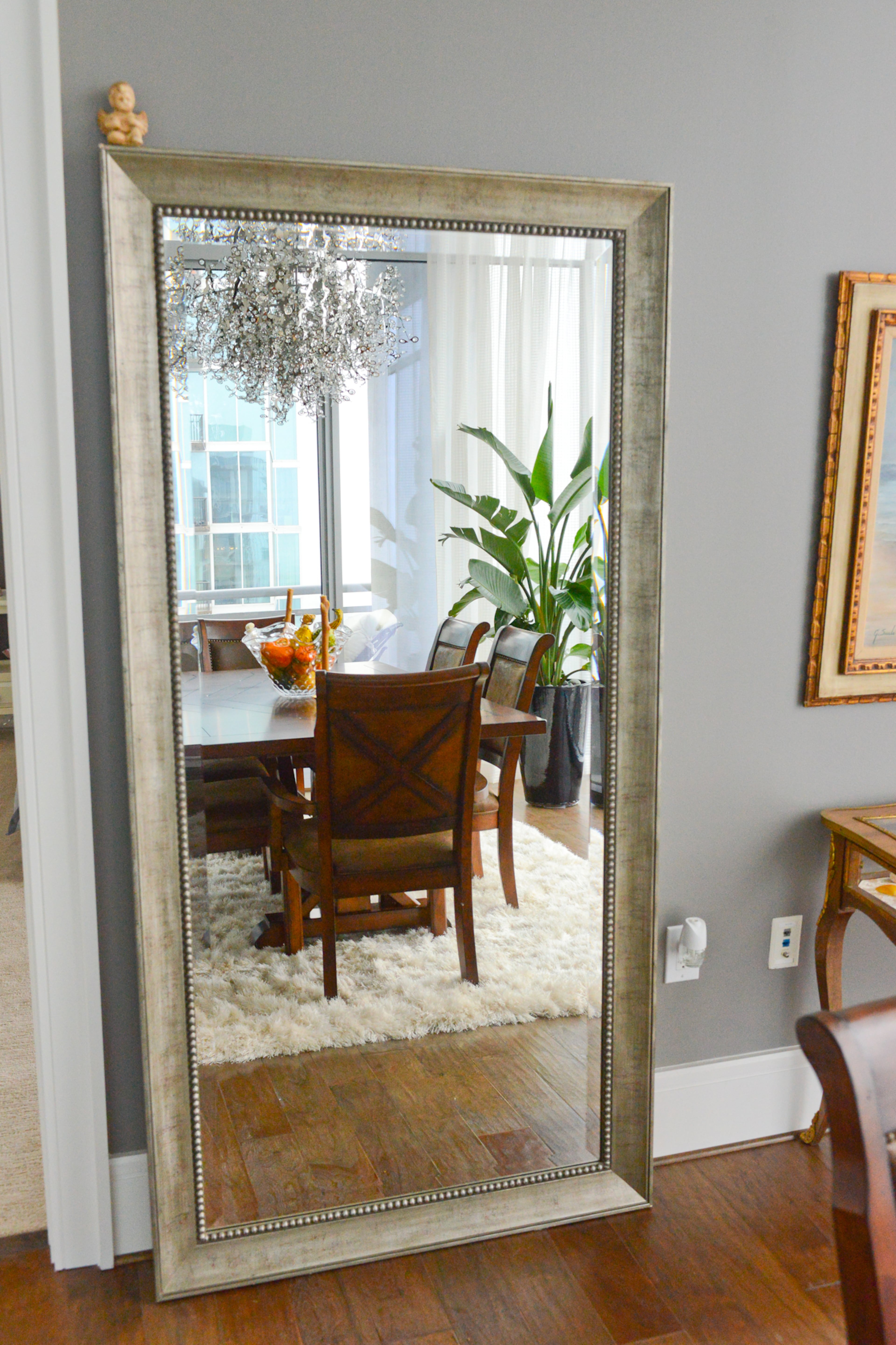A tall mirror reflects the light, open home Jim Wilson bought in Midtown Atlanta in 2015. Wilson has loved the 1065 Midtown high rise since it was built in 2010, and jumped at the chance to buy when the former rental property converted to condos.
