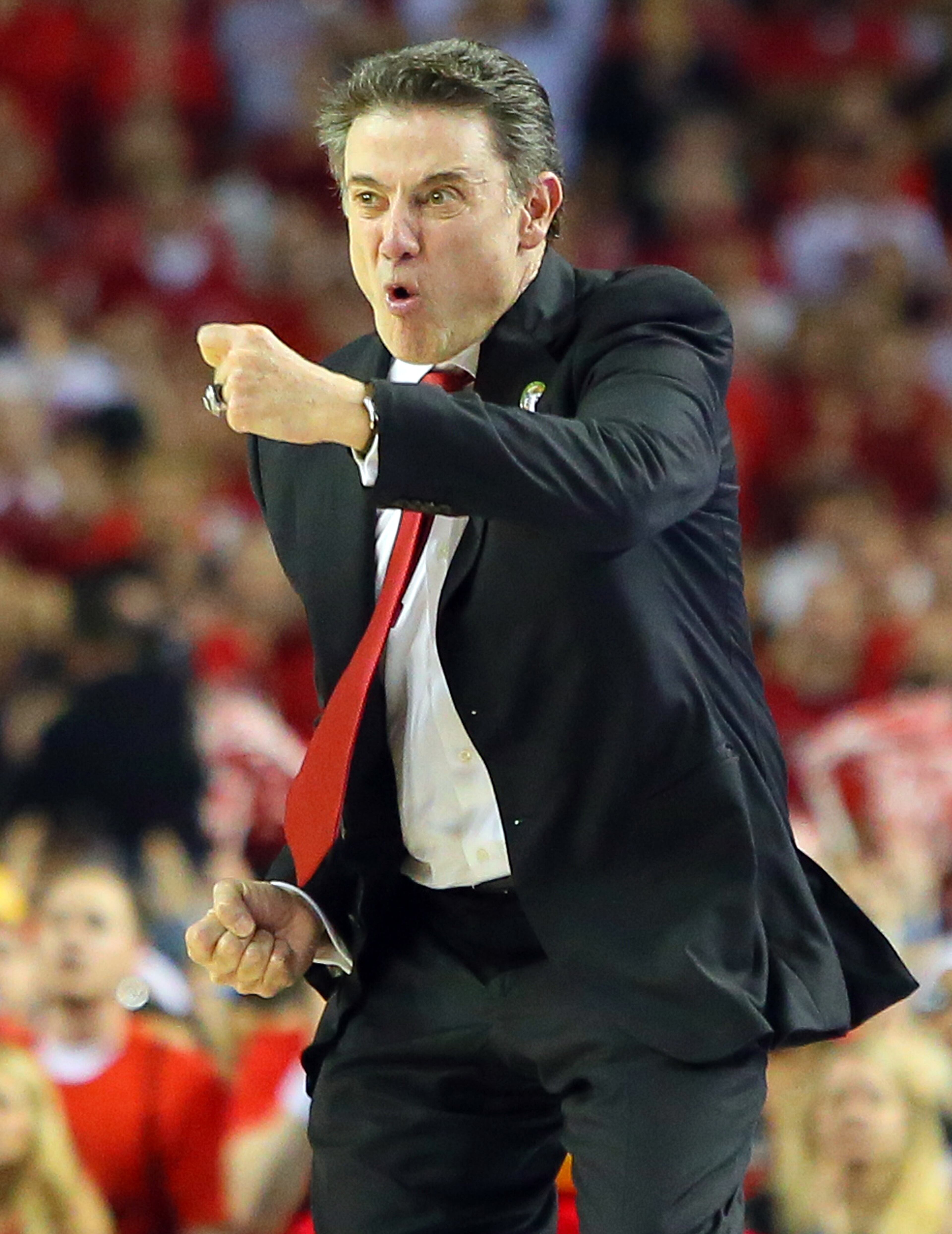 040813 ATLANTA: Louisville head coach Rick Pitino urges his team on defense in the final minutes of a 82-76 victory over Michigan to win the NCAA Division I National Championship on Monday, April 8, 2013, in Atlanta. CURTIS COMPTON/ CCOMPTON@AJC.COM