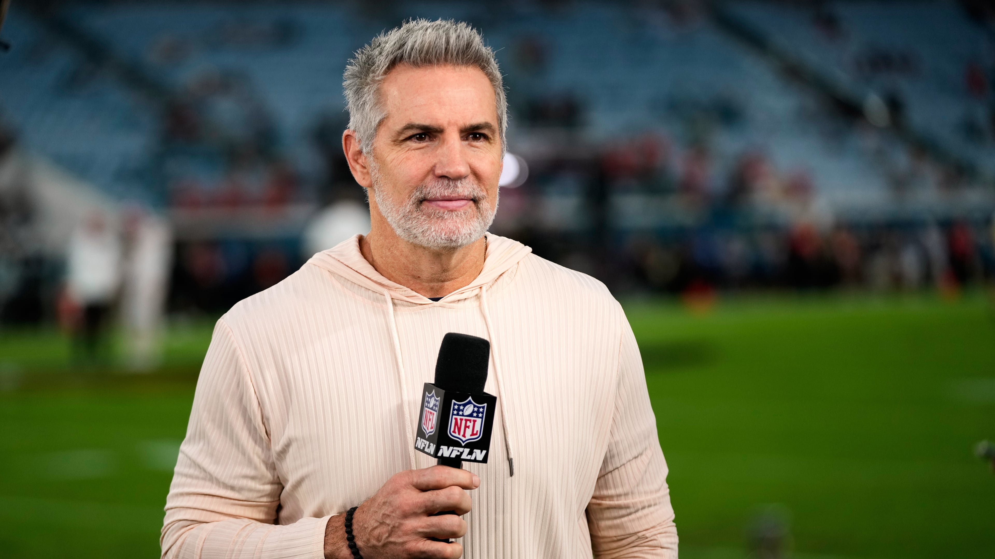 FILE - NFL Network analyst Kurt Warner reports before an NFL football game between the Jacksonville Jaguars and the Kansas City Chiefs, Oct. 6, 2025, in Jacksonville, Fla. (AP Photo/John Raoux, File)
