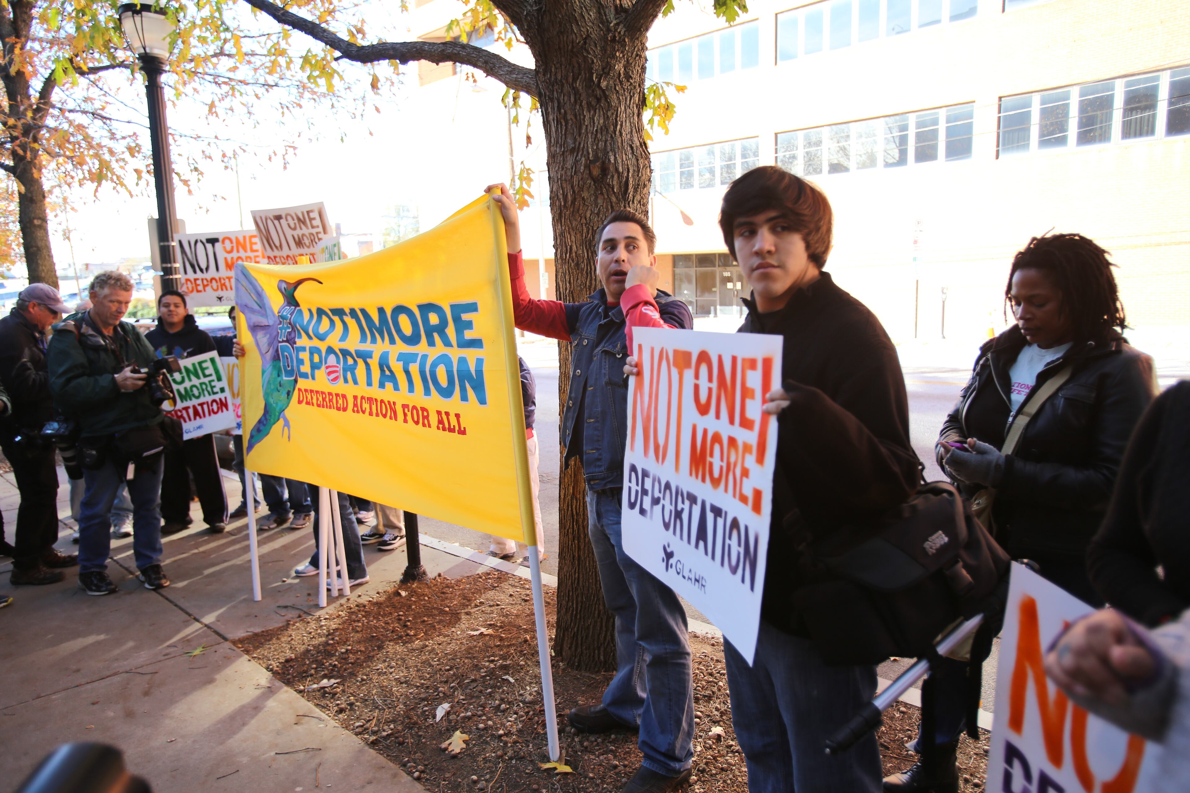 Activists locked themselves to the gates outside a federal government building in downtown Atlanta Tuesday as part of a boisterous demonstration against the Obama administration's immigration enforcement policies. Witnesses said authorities used bolt cutters to break the bicycle locks the activists used and took 14 people into custody just outside a building that houses U.S. Immigration and Customs Enforcement offices and federal immigration courtrooms.