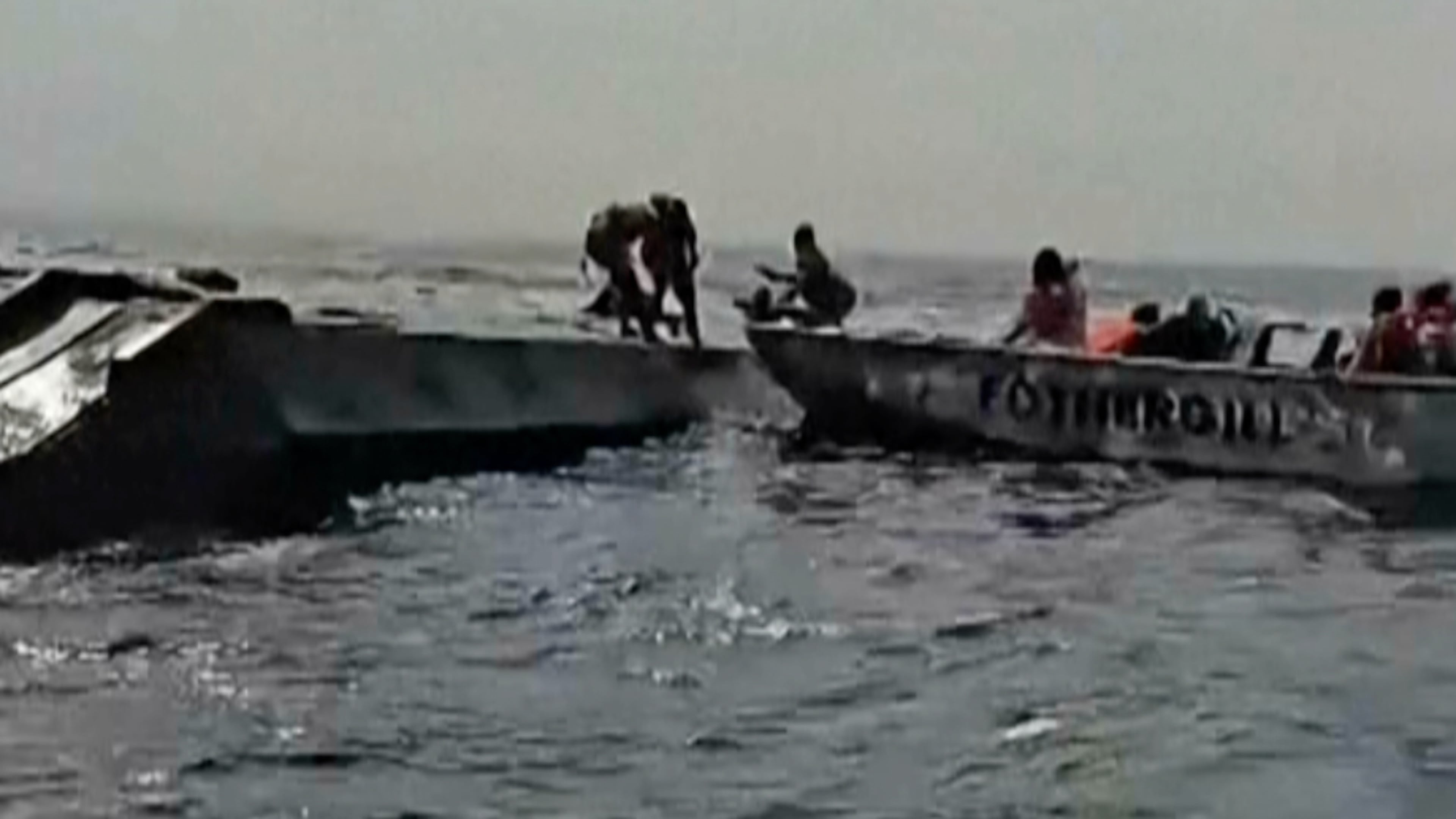 In this image taken from a video people are rescued from an overloaded ferry that capsized on Zimbabwe's Lake Kariba on Tuesday, Aug. 11, 2026. (Maxton Kanhema via AP)