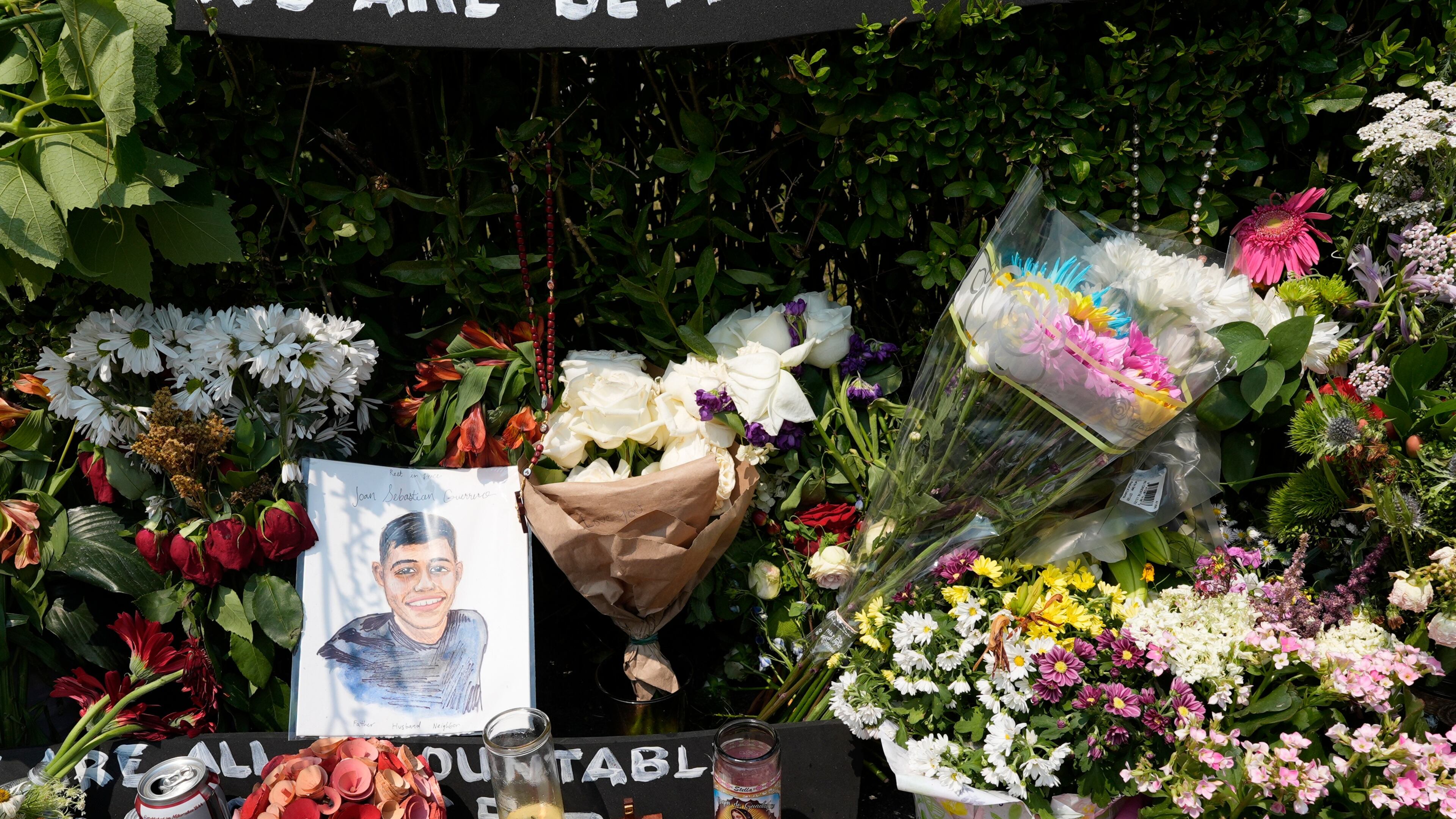 A portrait of Johan Sebastián Durán Guerrero, the man killed by U.S. Immigration and Customs Enforcement, is displayed among flowers and tributes at a makeshift memorial in Biddeford, Maine, Wednesday, July 15 2026. (AP Photo/Robert F. Bukaty)