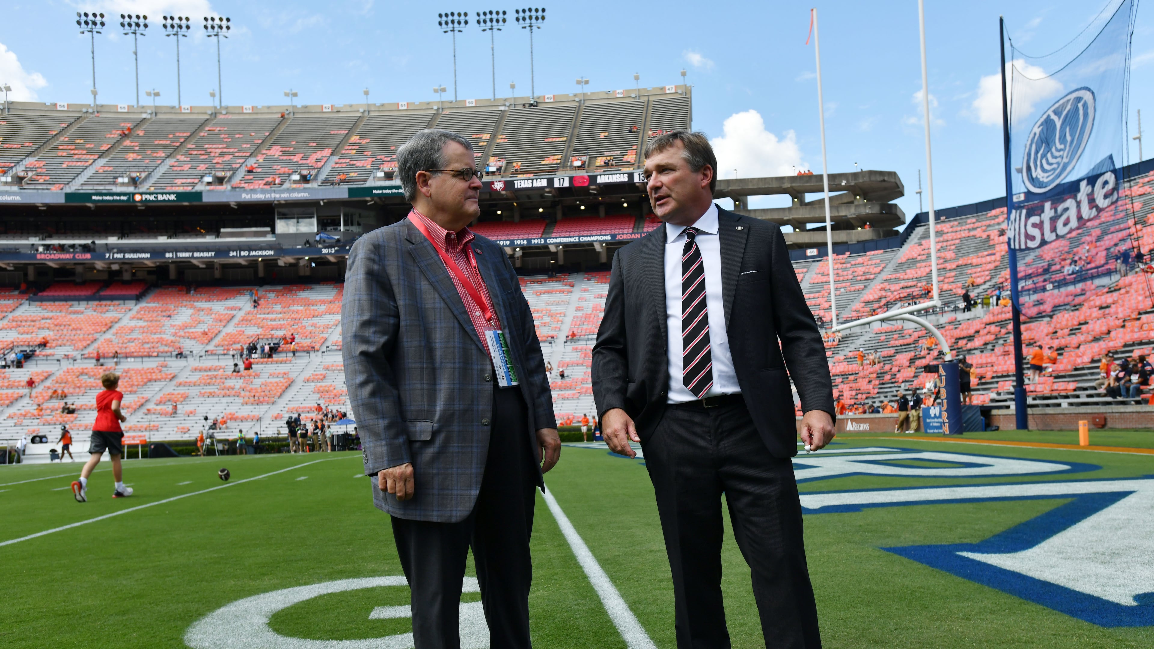 Georgia head coach Kirby Smart (right) talks with Georgia president Jere Morehead before their game against Auburn at Jordan-Hare Stadium, Saturday, Sept. 29, 2023, in Auburn, Alabama. (Hyosub Shin/AJC)