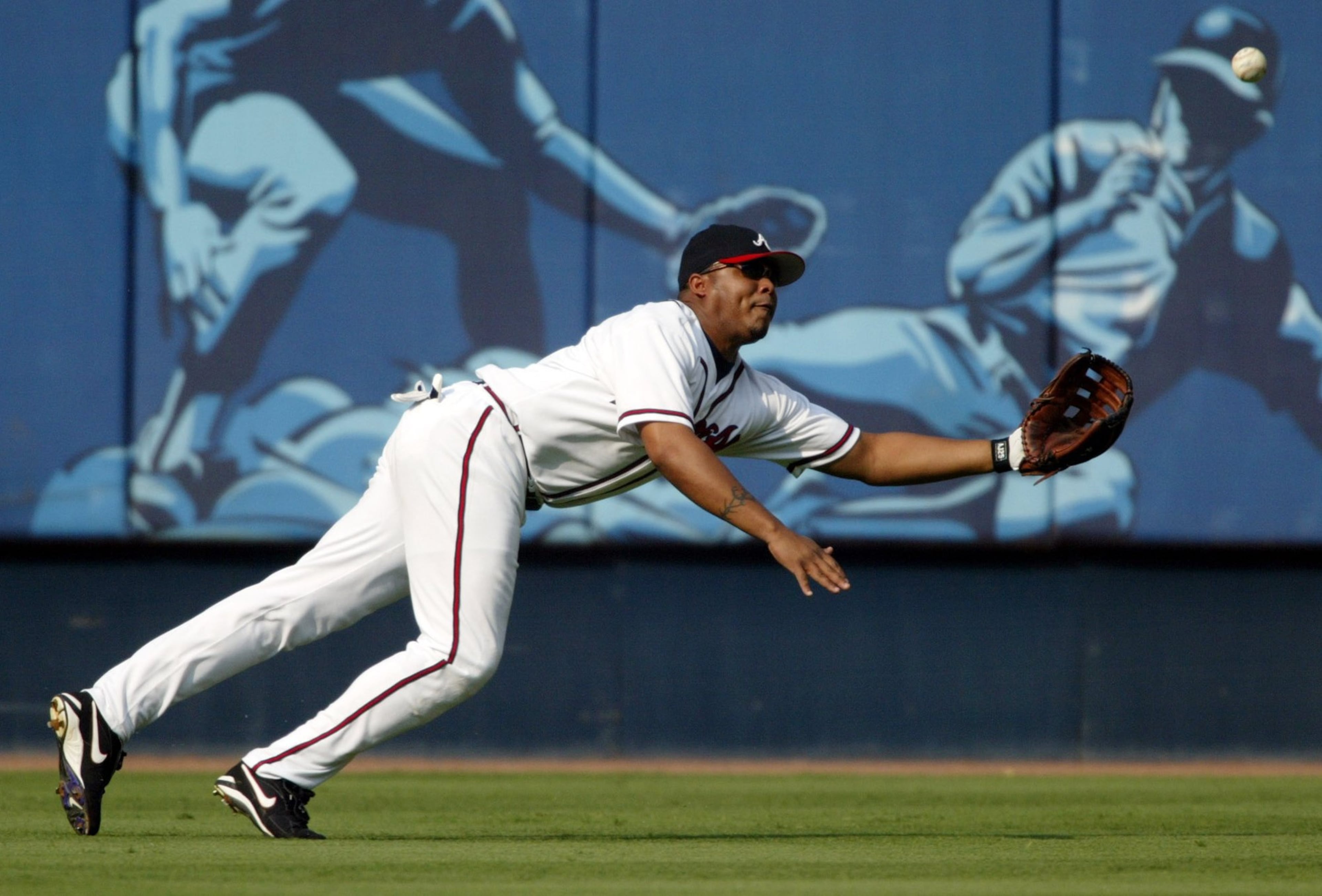 Braves center fielder Andruw Jones makes a diving catch against Pittsburgh shortstop Jack Wilson on Friday, Sept. 5, 2003, at Turner Field in Atlanta. (Brant Sanderlin/AJC)