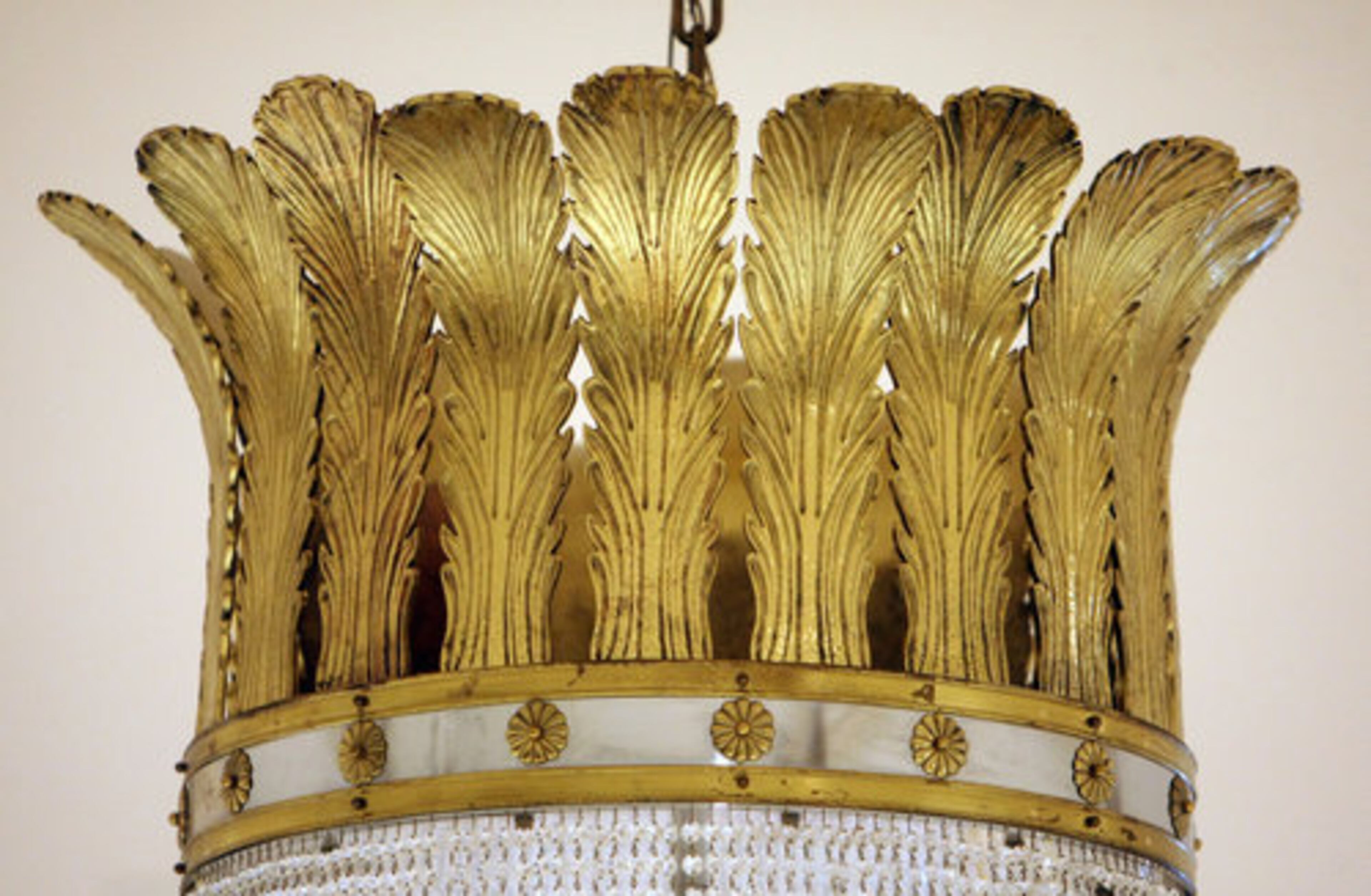 The 14-foot chandeliers have many gold accents.