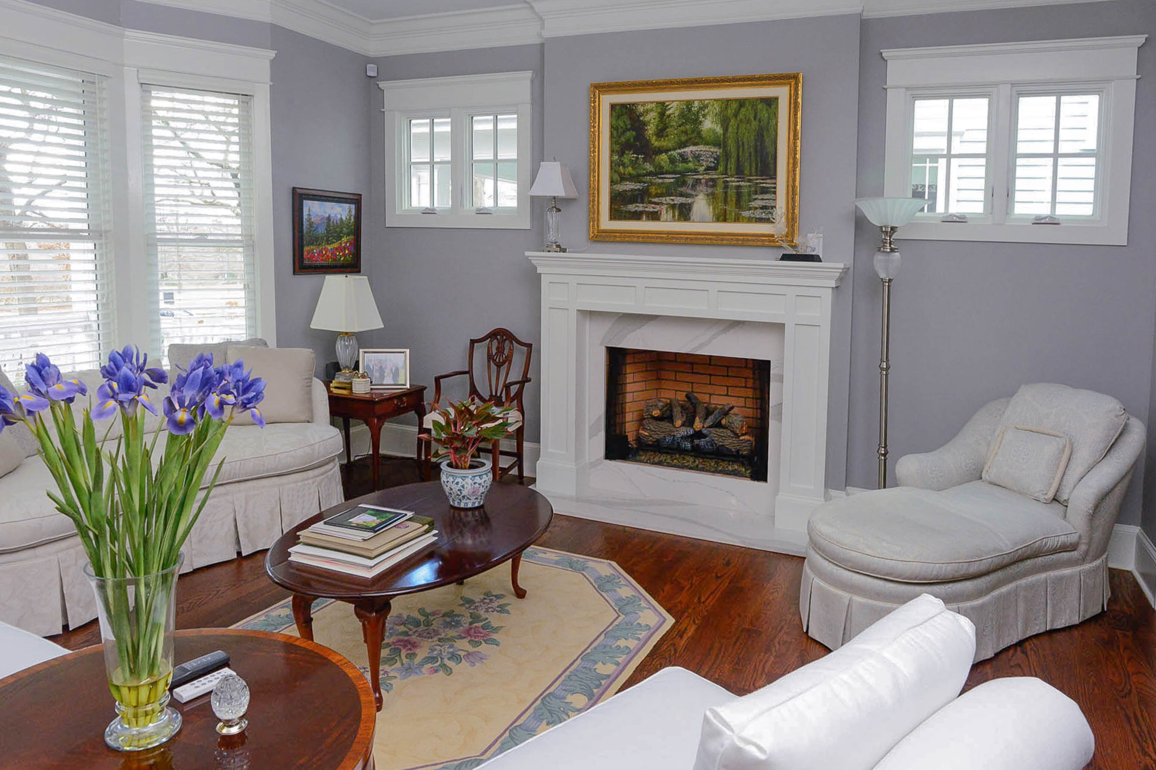 Reupholstered furniture casts shapely silhouettes in the formal living room. The room is painted in Behr's Classic Silver while the trim is in Benjamin Moore's Snowfall White.