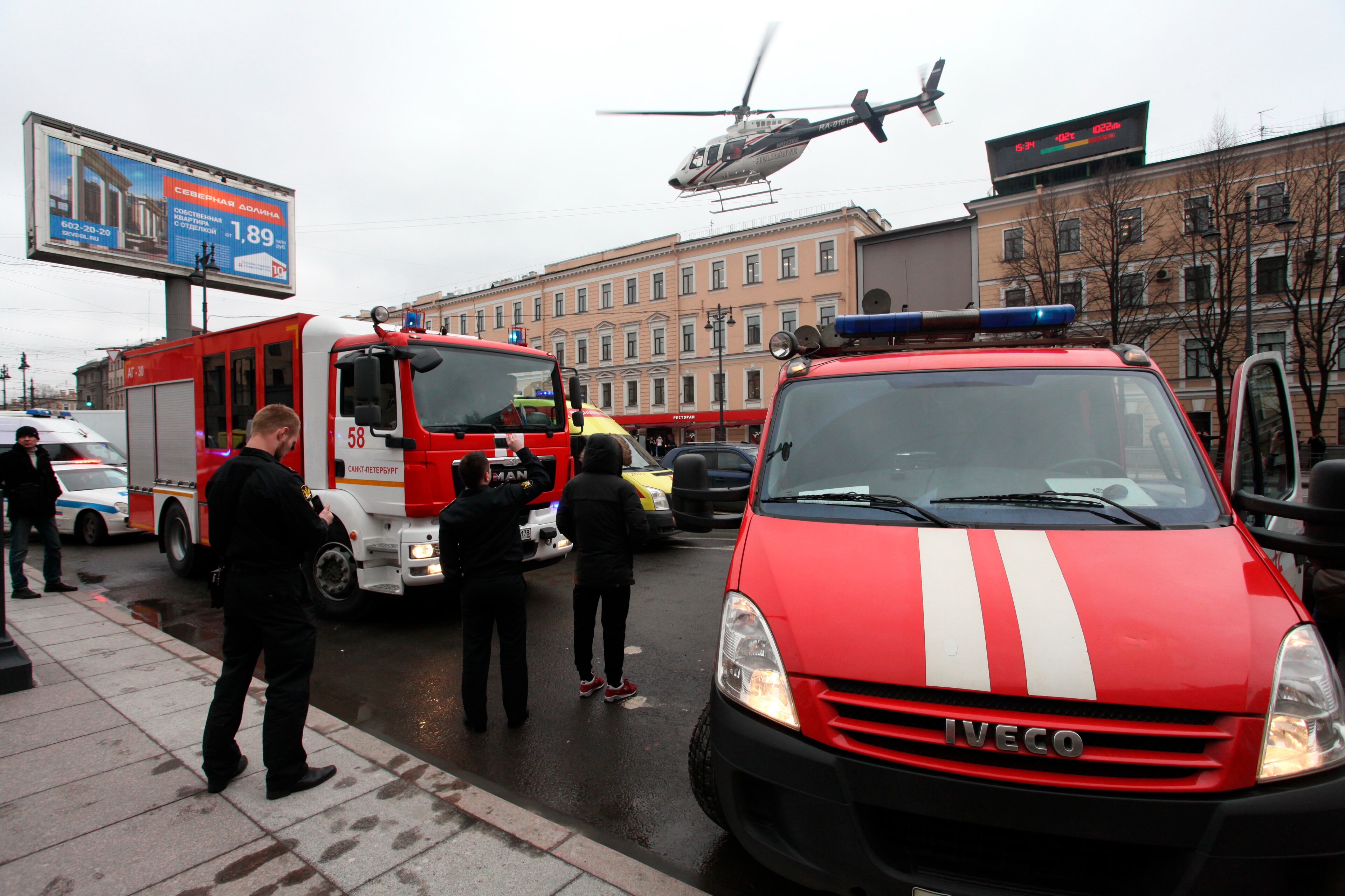 A helicopter flies over the fire trucks after an explosion at Tekhnologichesky Institut subway station in St.Petersburg, Russia, Monday, April 3, 2017. The subway in the Russian city of St. Petersburg is reporting that there are fatalities and several people have been injured in an explosion on a subway train. (Alexander Tarasenkov/Interpress via AP)