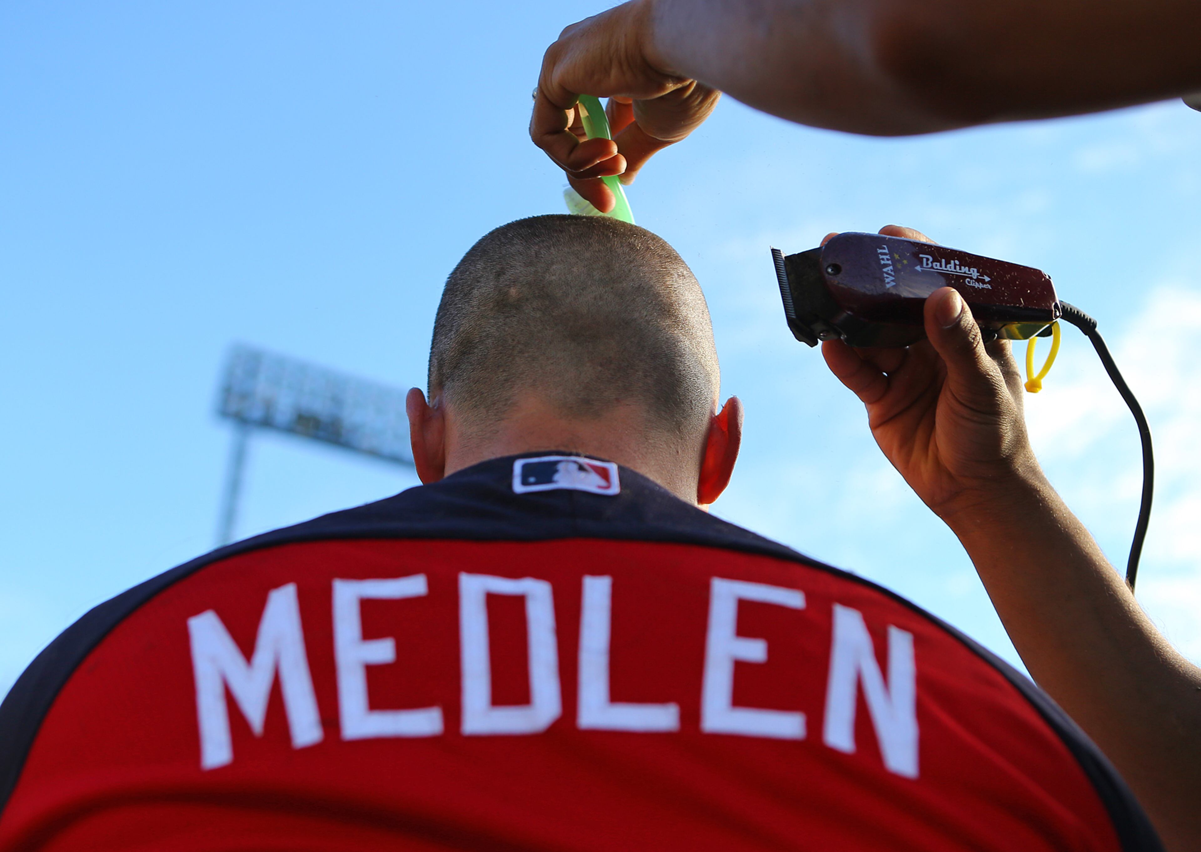 Braves pitcher Kris Medlen has his head shaved to help raise awareness and funding for cancer research at spring training on Wednesday, Feb. 19, 2014, in Lake Buena Vista, FL. CURTIS COMPTON / CCOMPTON@AJC.COM