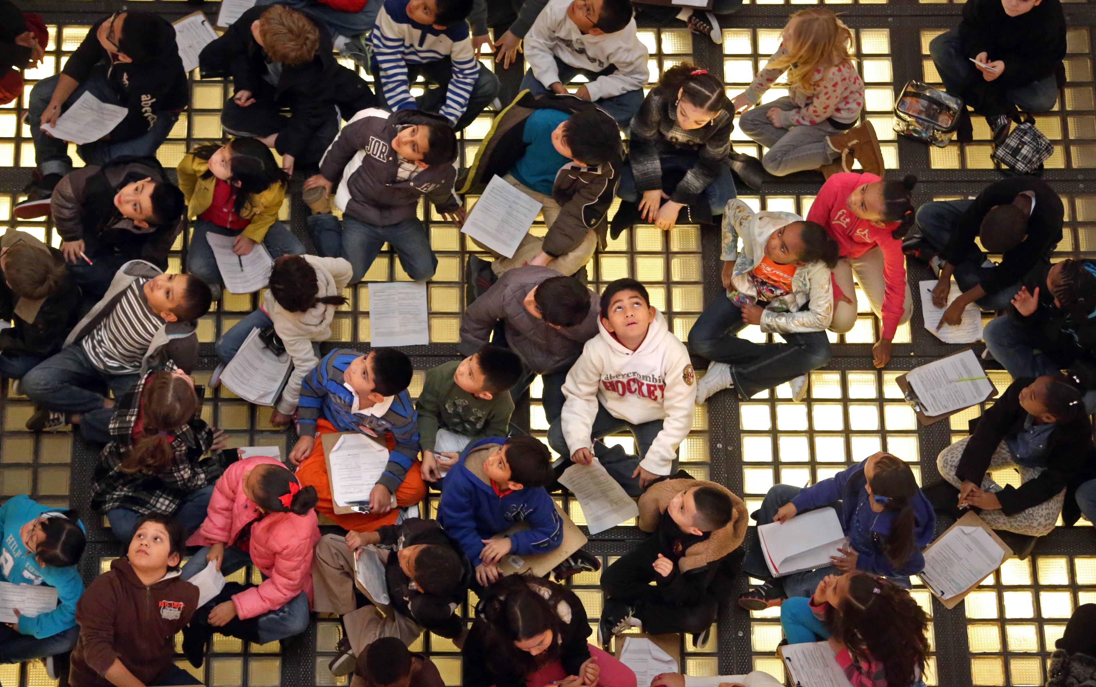 DAY 5- Third grade students from Benefield Elementary School in Lawrenceville sit on the glass bricks and look up at the Capitol Rotunda as they listen to a guided tour by Tracie Murray (not pictured). The glass tiles in the floor of the Rotunda were originally skylights that brought light to government agencies located on the first floor. Today lights have been placed under the glass panels to bring light into the rotunda. The glass tiles were also the site of a make-shift Governor's office.