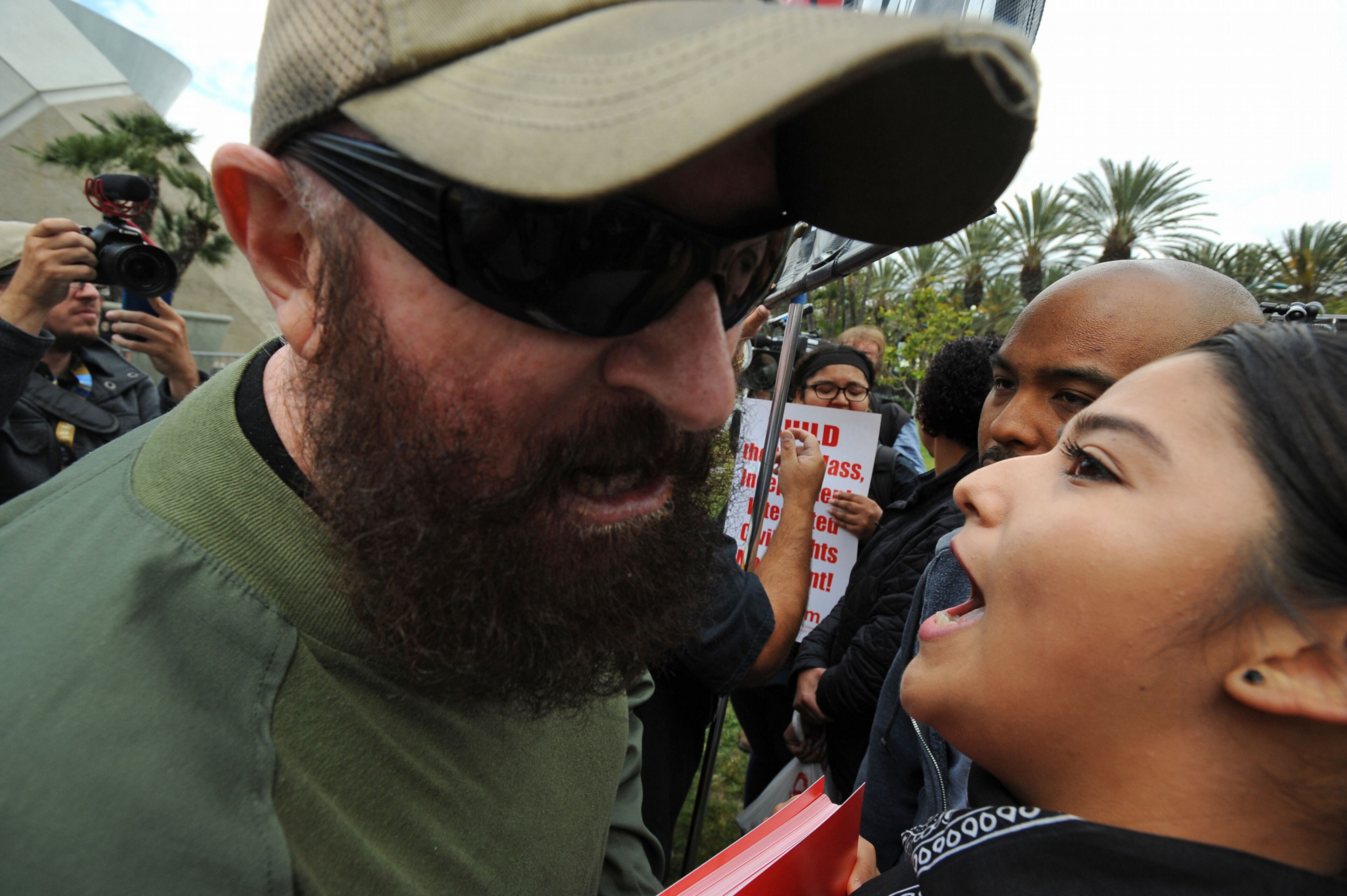 Protesters face-off outside a Donald Trump rally at the Anaheim Convention Center on Wednesday, May 25, 2016 in Anaheim, Calif. A small but vocal group of people protested outside a Donald Trump campaign rally Wednesday in Orange County amid a heavy police presence to guard against a repeat of raucous demonstrations at other Trump events. (Michael Goulding /The Orange County Register via AP)
